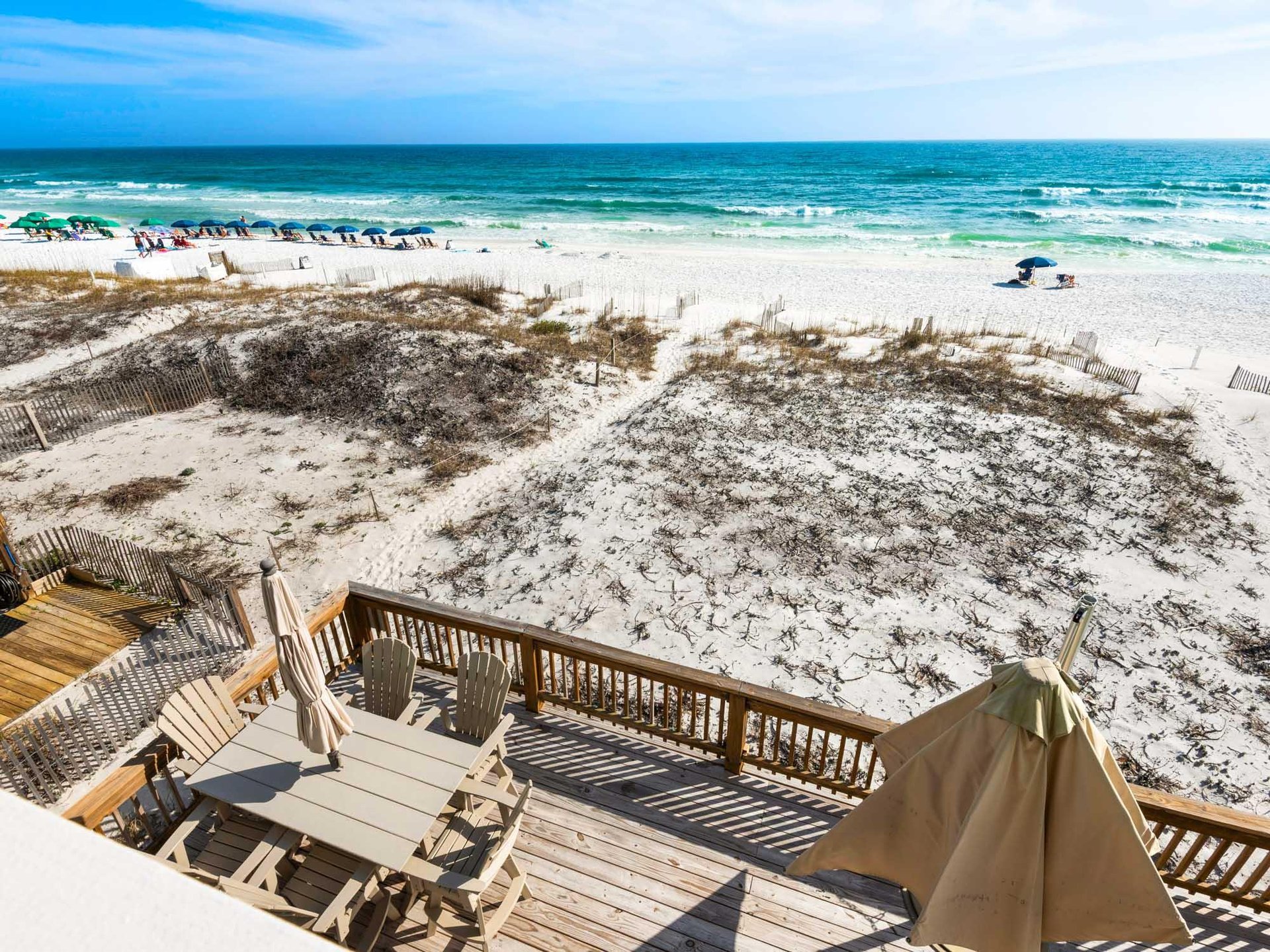 Beachfront property with private deck offering direct access to pristine Gulf waters and white sand dunes.