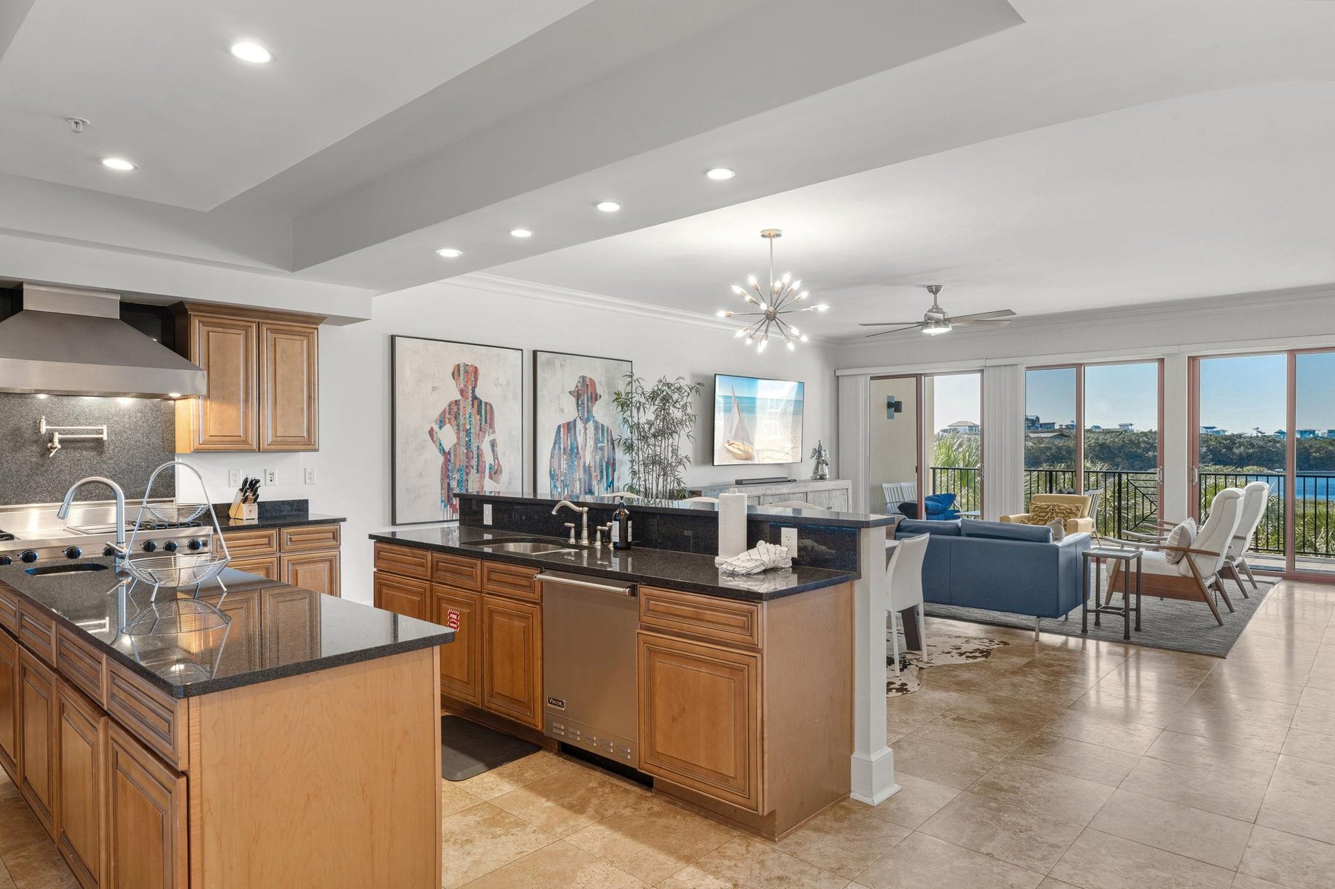This open kitchen flows seamlessly into the living space, featuring premium appliances and stunning water views through floortoceiling windows.