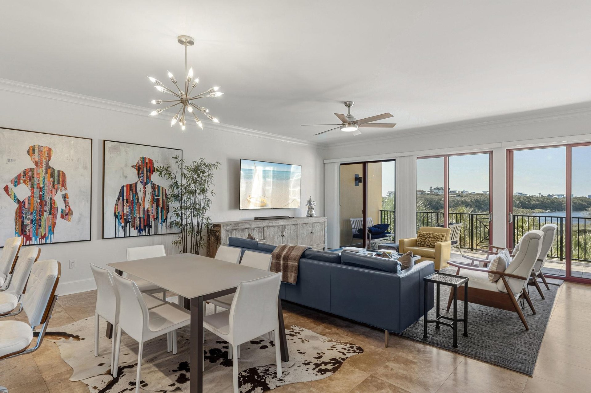 Unwind in this stylish living space where modern art meets comfort, with expansive windows framing peaceful views for your perfect getaway.