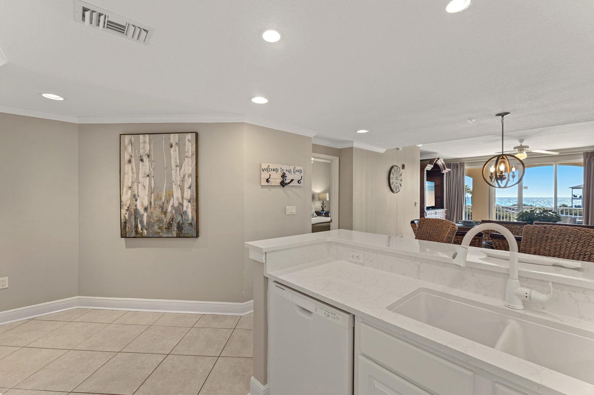 The modern kitchen flows seamlessly into the dining area, featuring gleaming quartz counters and sleek appliances for memorable meals together.