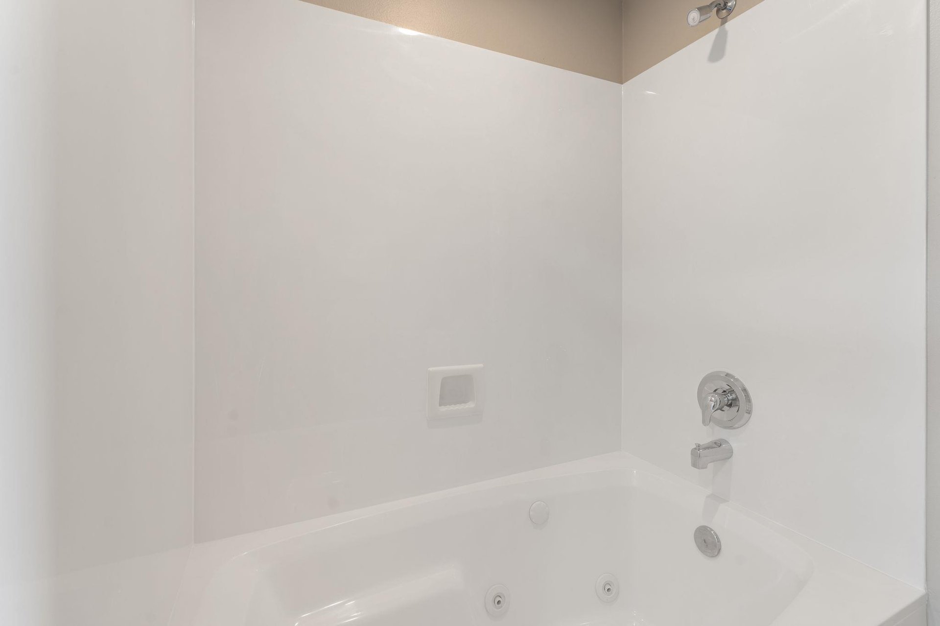 Slip into this pristine bathtub for a relaxing soak after your adventures, with clean white surroundings.