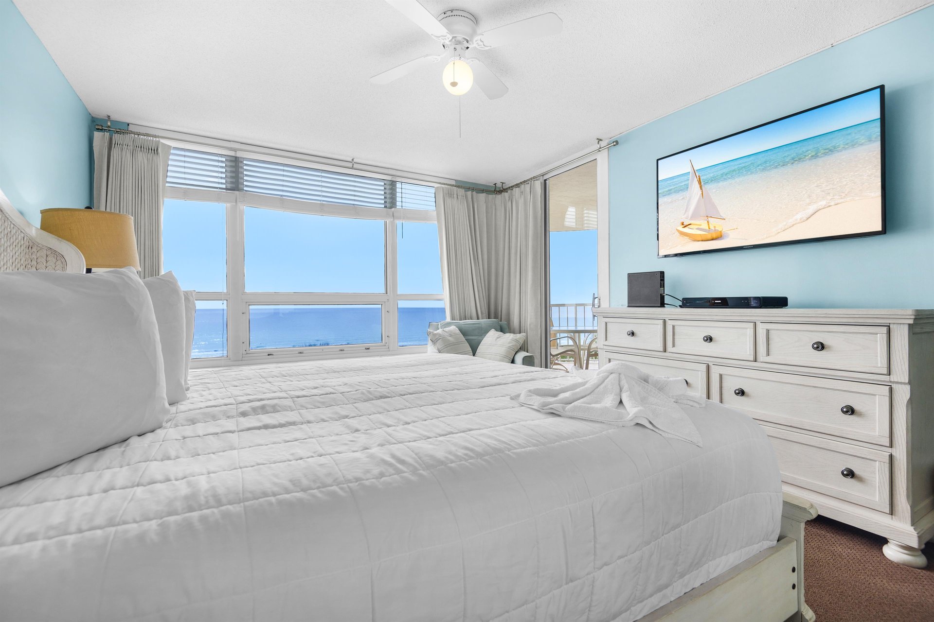 Wake to stunning ocean views through floortoceiling windows in your peaceful Bedroom 1 sanctuary with coastal charm.