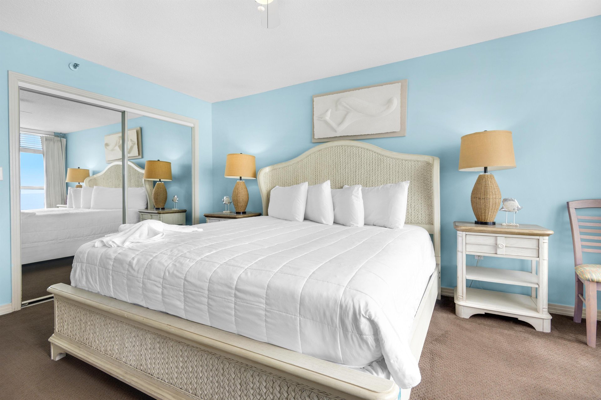 Bedroom 1 Drift off in your serene coastal bedroom, where soft blue walls and crisp white linens create a peaceful retreat for restful nights.