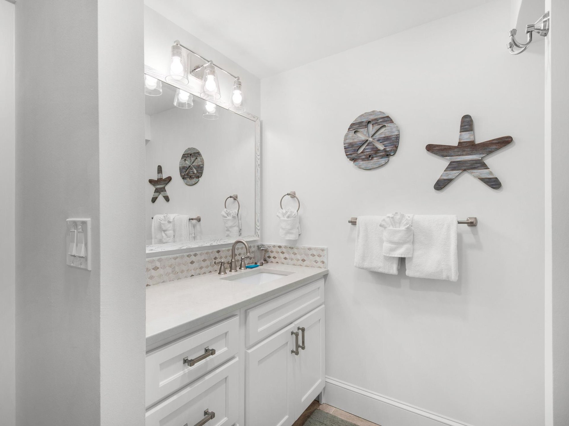 Bathroom 2  Step into your bright coastal bathroom with sparkling fixtures, beachthemed decor, and plush towels ready for your refreshing start.