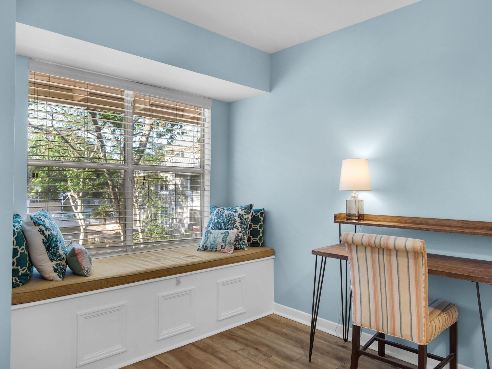 Bedroom 1  Settle into your cozy window seat with morning coffee, watching neighborhood life unfold through sundappled trees outside your peaceful retreat.
