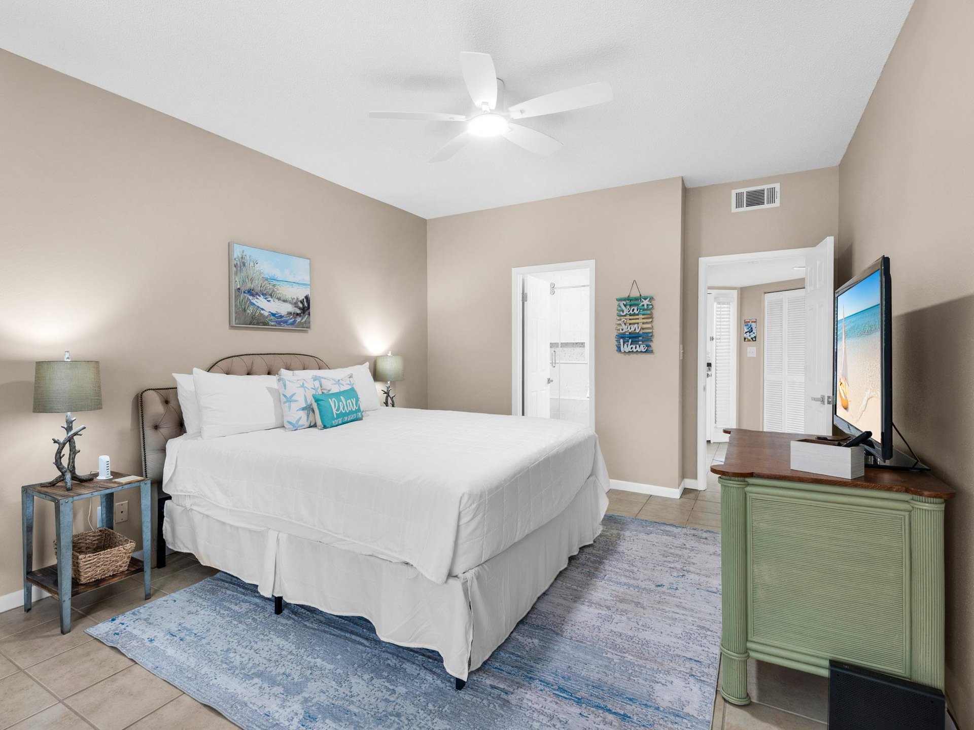 Bedroom 1 Drift off in your coastal retreat with crisp linens, oceanthemed touches, and modern comfort—complete with ceiling fan and flatscreen TV.