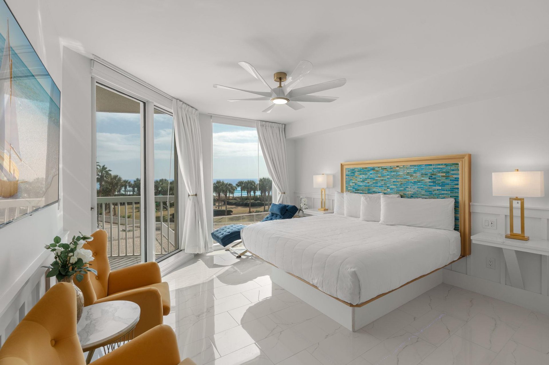 Bedroom 1 with King bed pristine white linens and stunning ocean views from your bright, airy bedroom retreat.