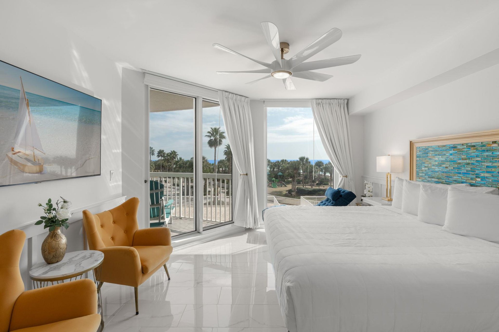 Wake up to tropical views from your bright bedroom with palm trees swaying beyond your private balcony.