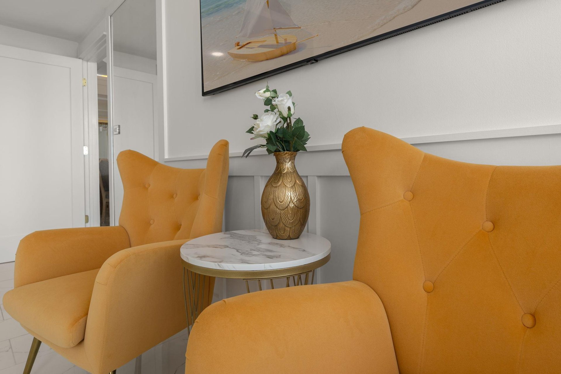 Settle into these plush mustard armchairs with your morning coffee, your perfect reading nook.
