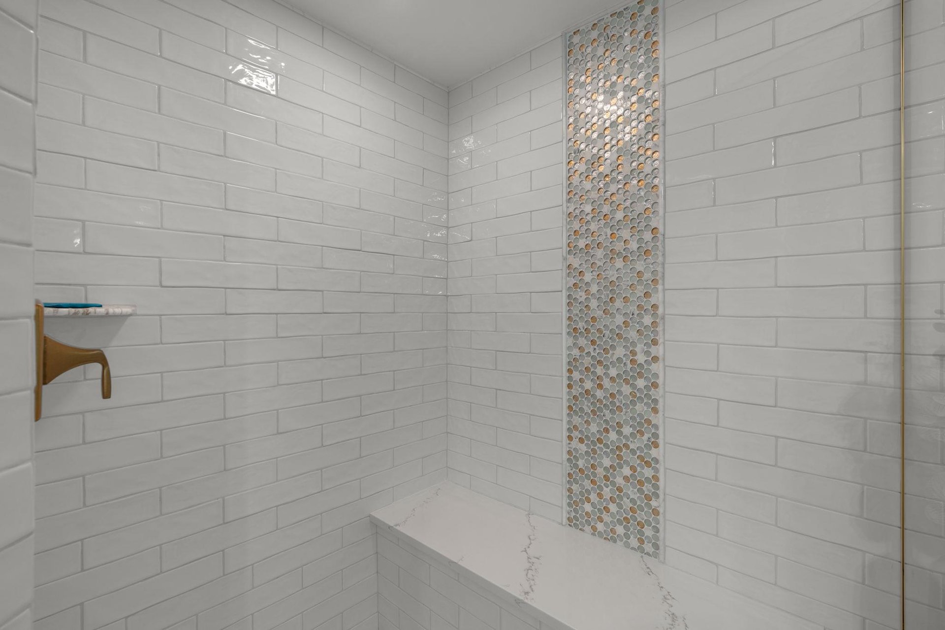 Refresh in a spalike shower with gleaming subway tiles and stunning mosaic accent wall for daily luxury.