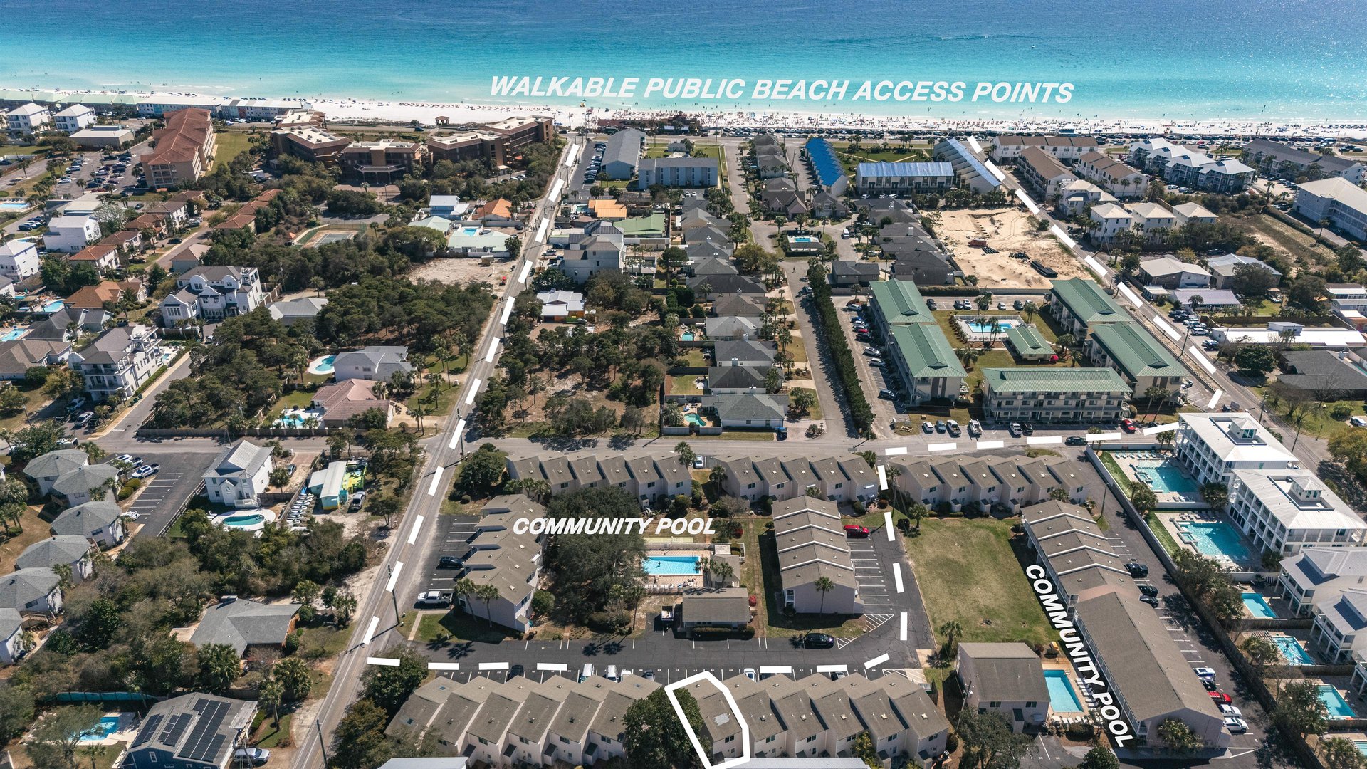 Aerial view of a beachside community with easy access to pristine white sand beaches and community amenities nearby.
