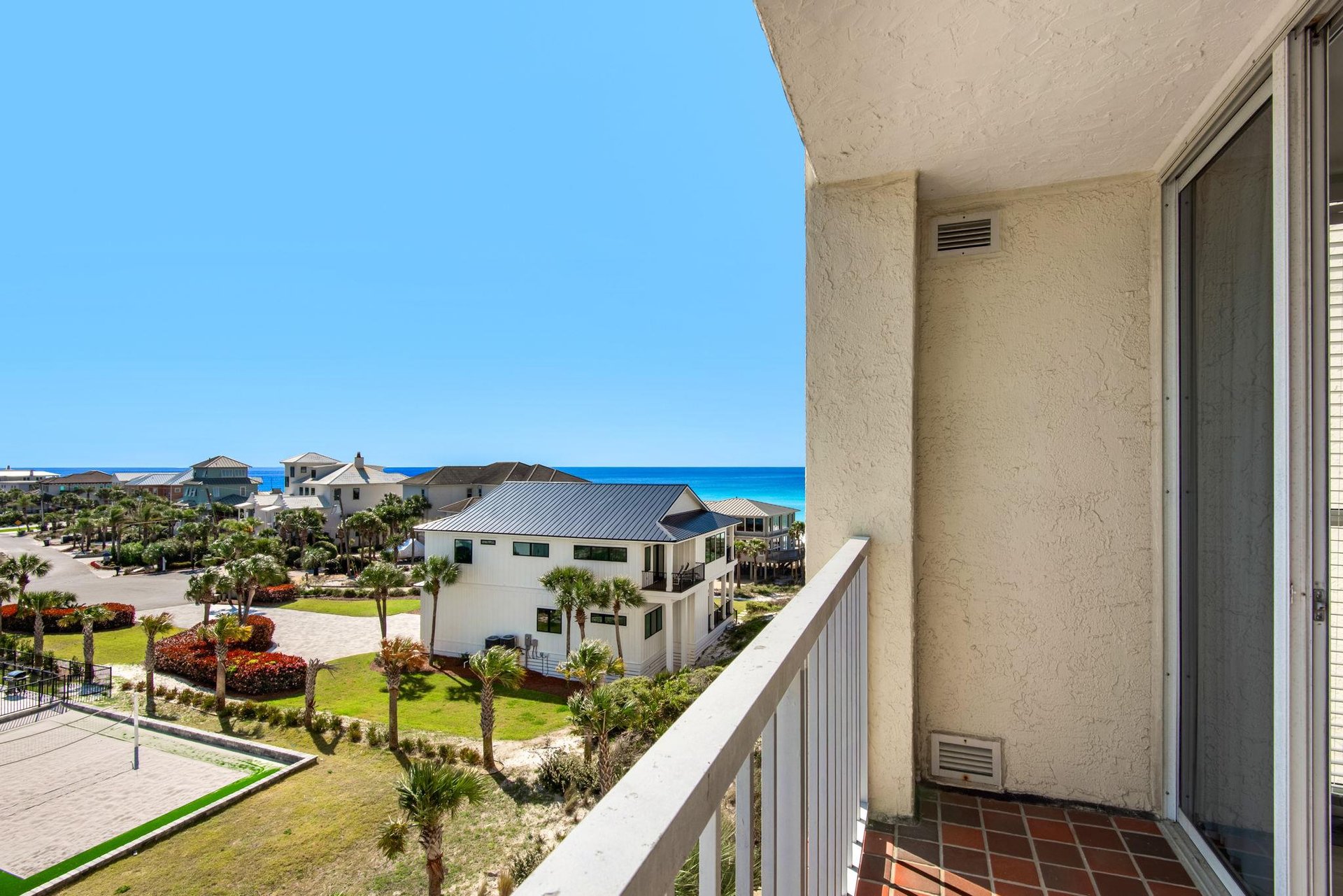 Stunning sea views await from your private balcony, where turquoise waters meet coastal homes below.