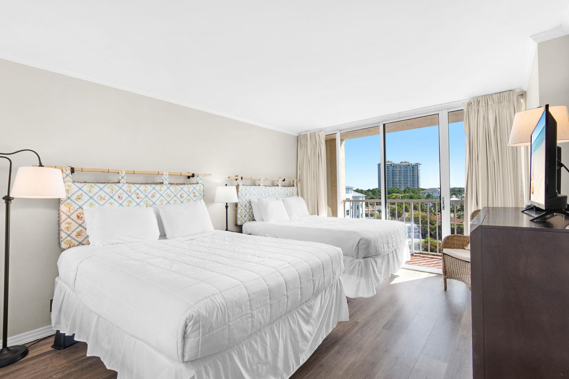 Relax in your bright bedroom with two comfortable beds, city views, and modern amenities for a perfect getaway.