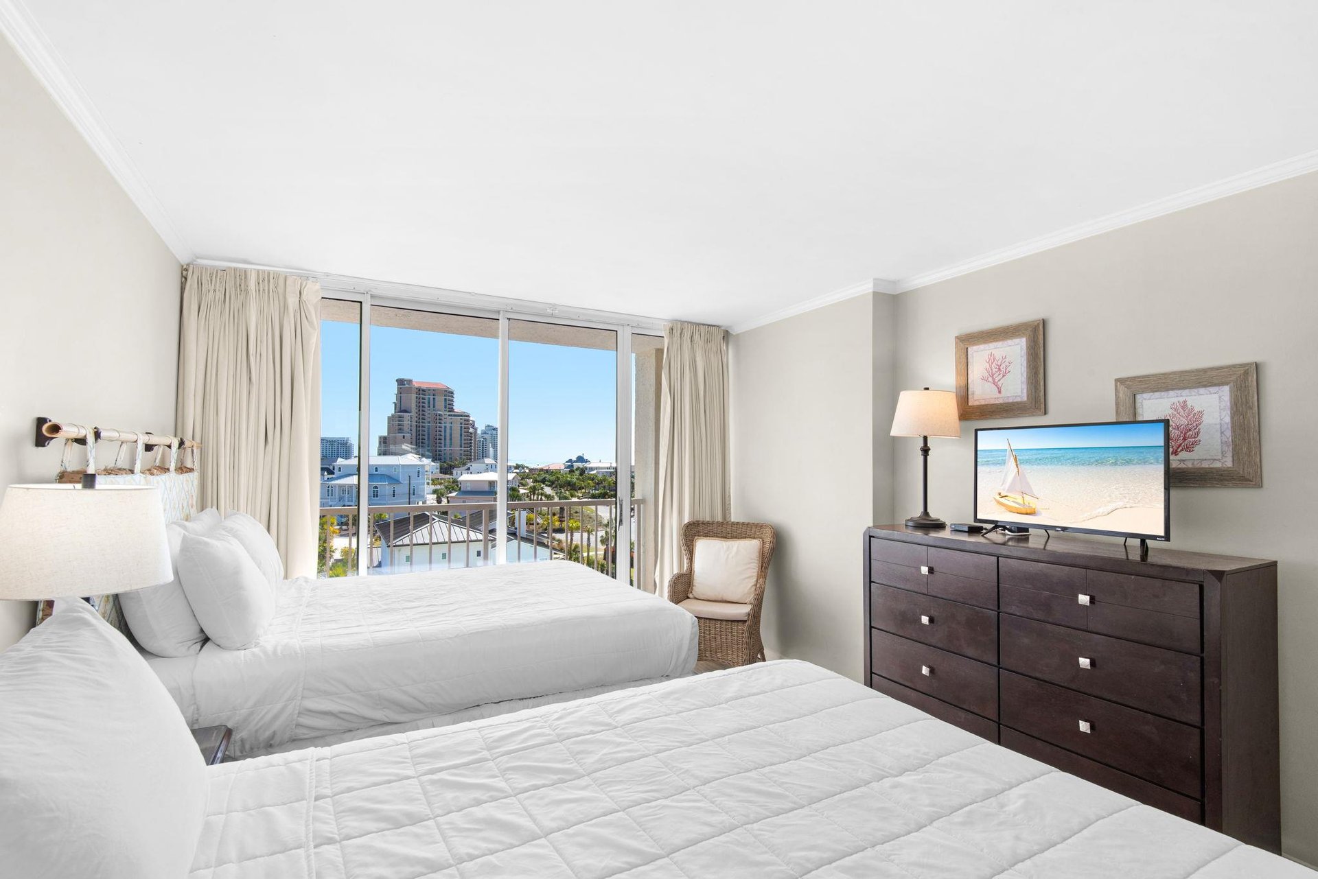 Wake up in your bright, comfortable bedroom with two plush beds and stunning city views through floortoceiling windows.