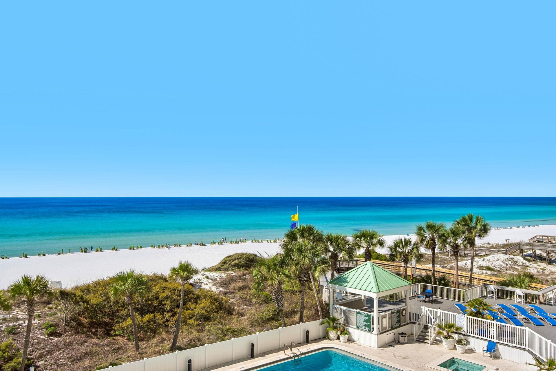 Stunning beachfront property with pristine white sand beach and crystalclear turquoise waters stretching to the horizon.