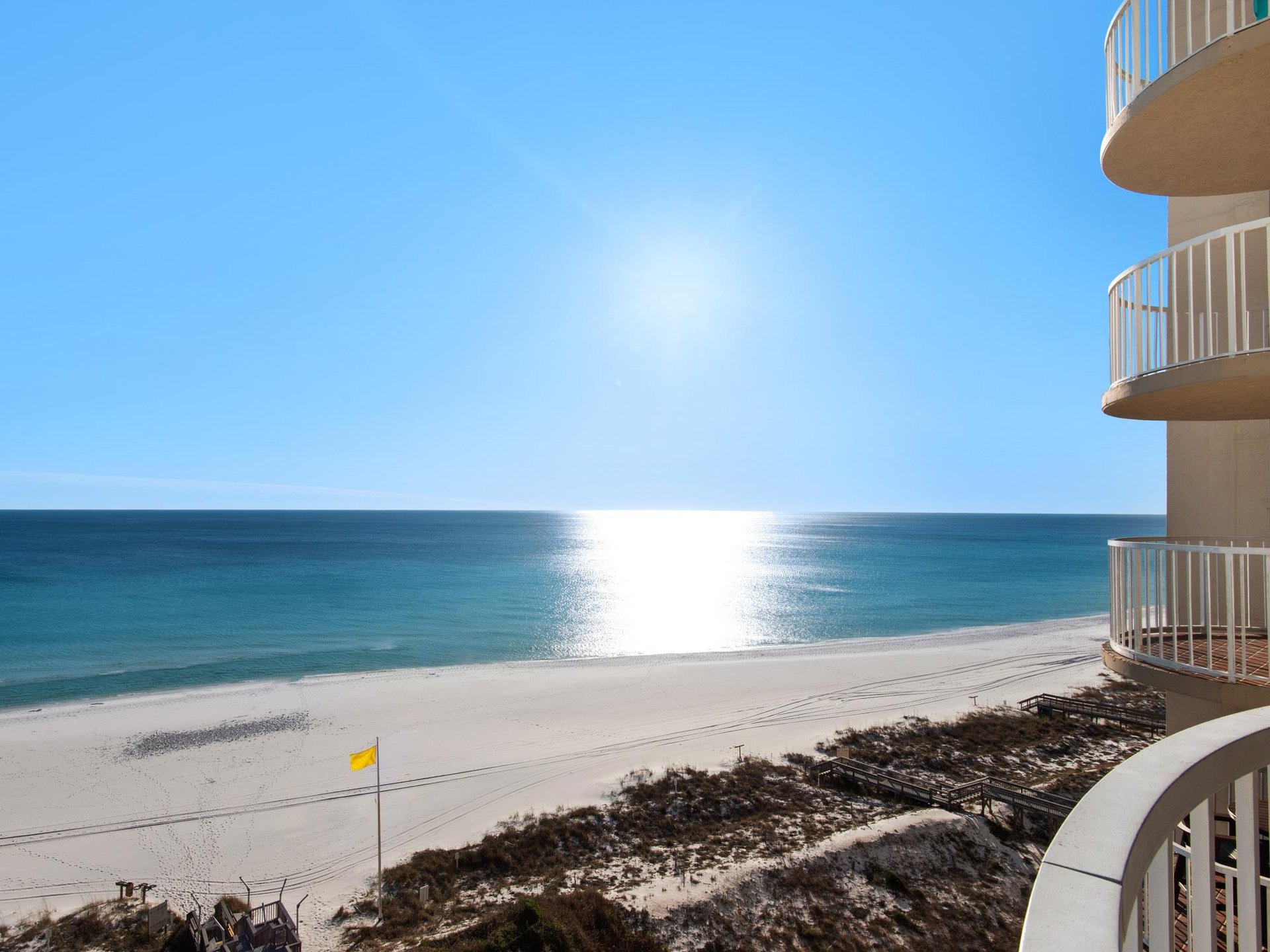 Stunning beachfront property with pristine white sand beach and crystalclear waters stretching to the horizon.