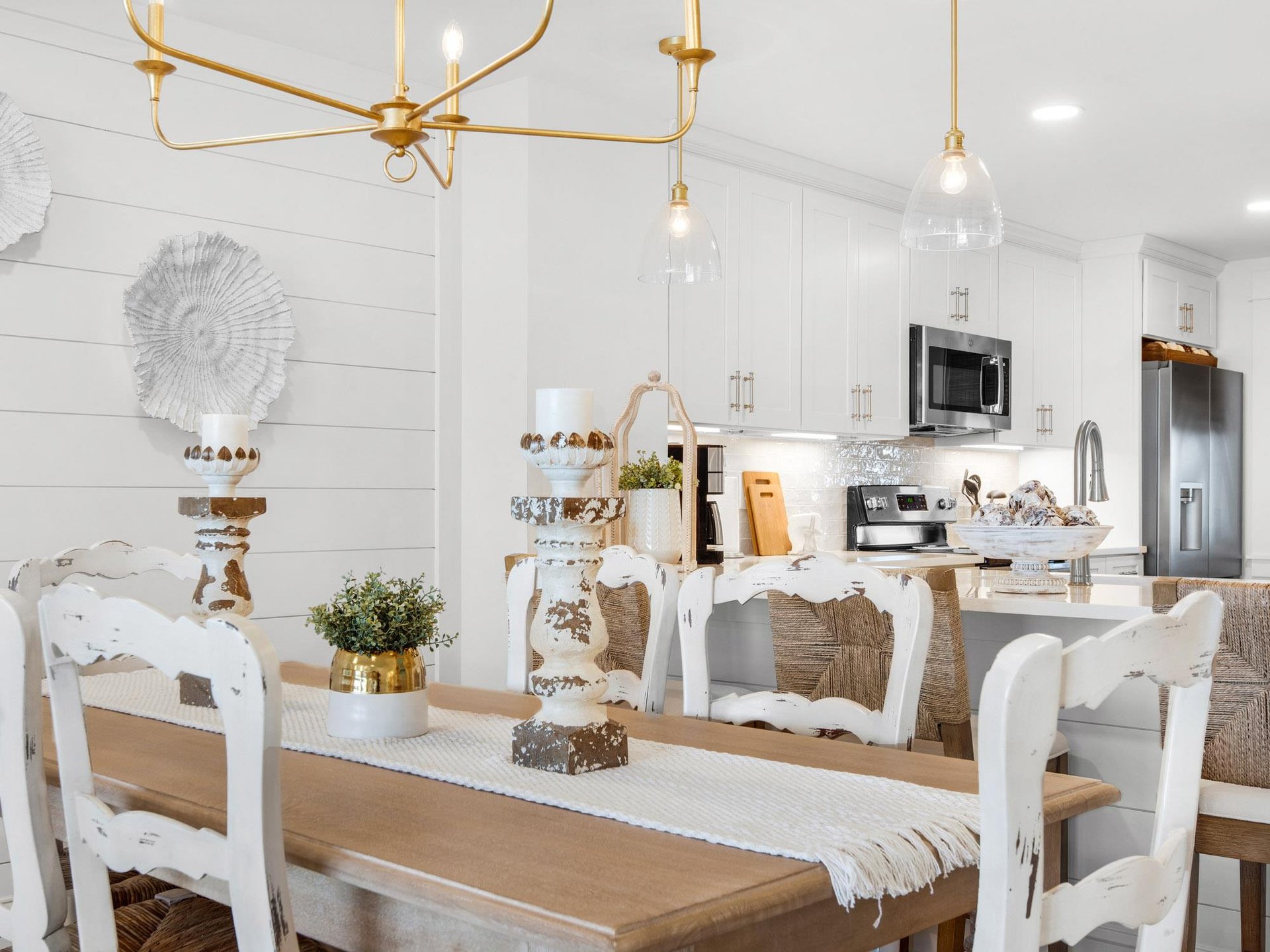 Your bright coastal dining space flows seamlessly into the fully equipped kitchen, perfect for hosting memorable meals together.
