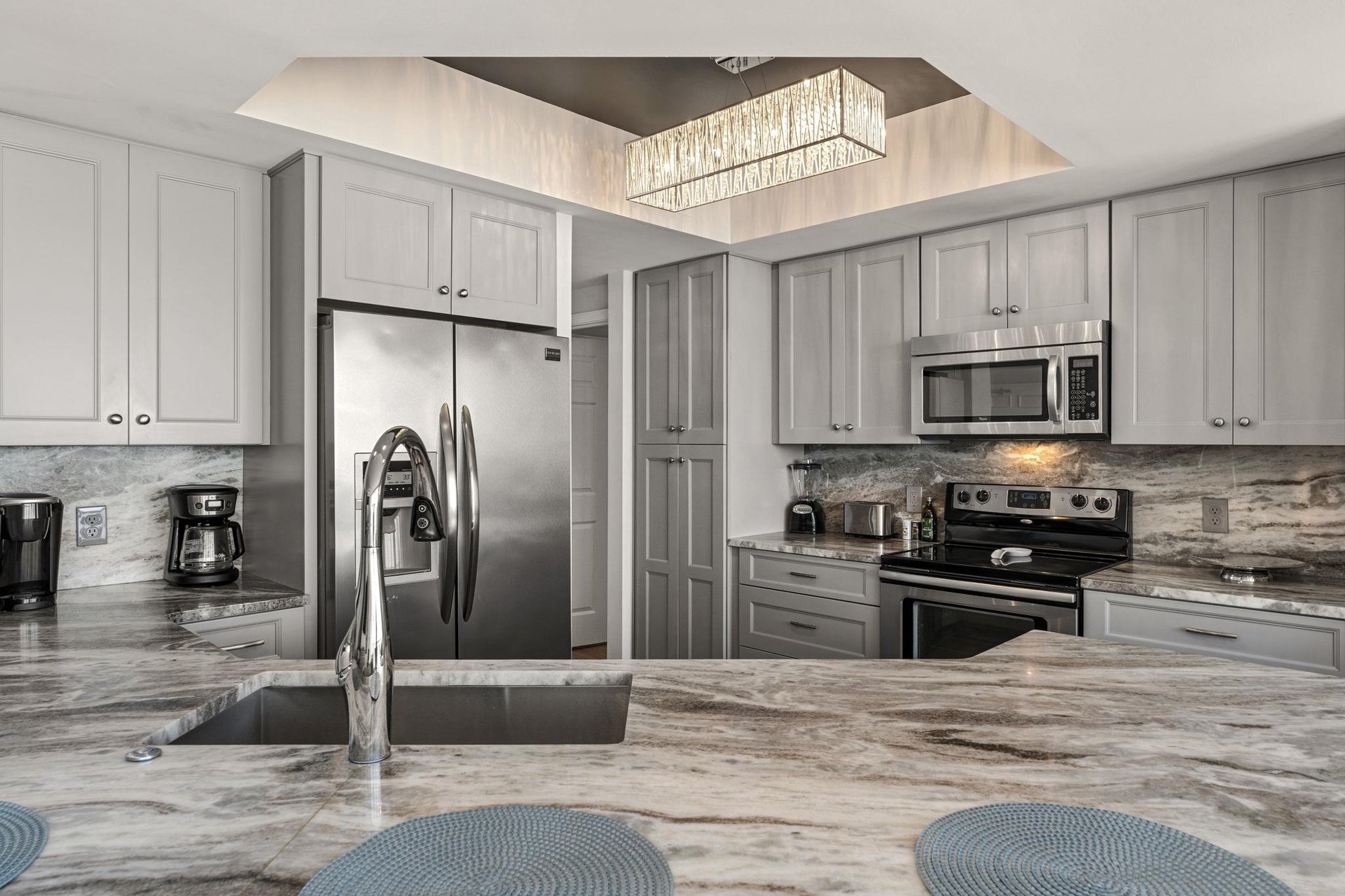 Your gourmet kitchen awaits with granite counters, stainless appliances, and elegant lighting to inspire memorable meals together.