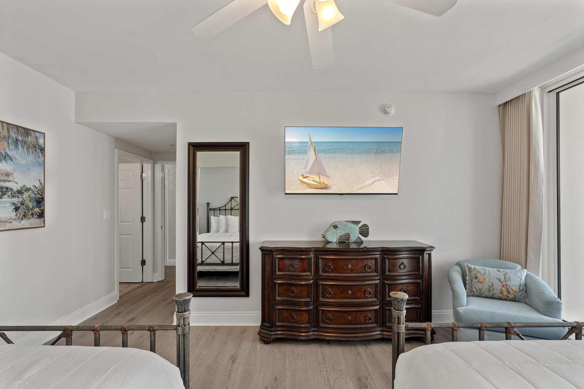 Unwind in your coastalthemed bedroom with ocean artwork and elegant furnishings creating a serene retreat.