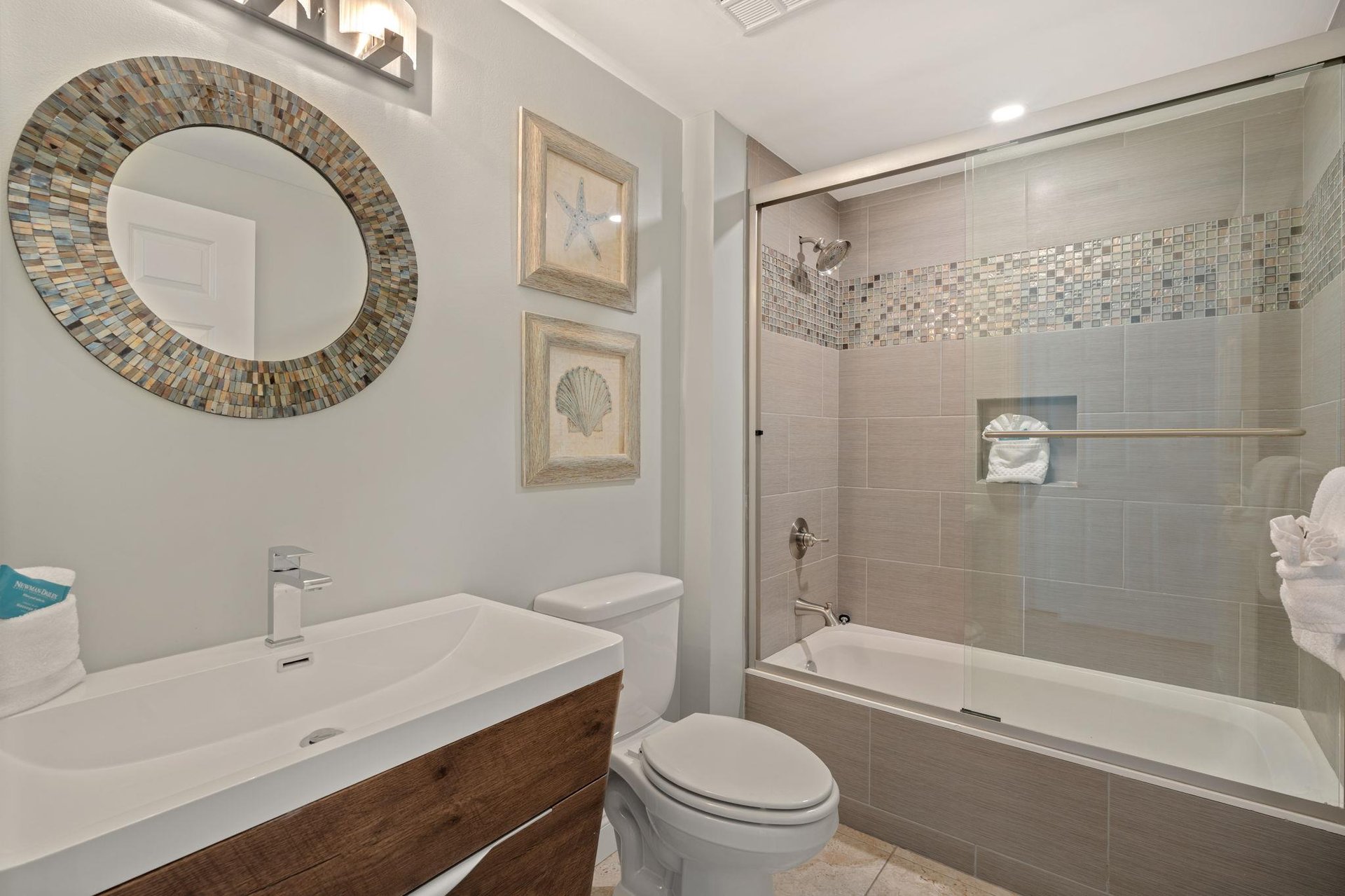 Unwind in your beautifully appointed bathroom featuring elegant mosaic details and a relaxing tub for your perfect getaway.