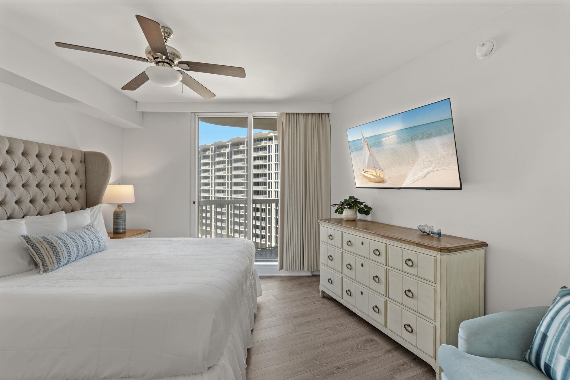 Unwind in your serene bedroom with coastal décor, city views, and gentle ceiling fan breezes to lull you to sleep.