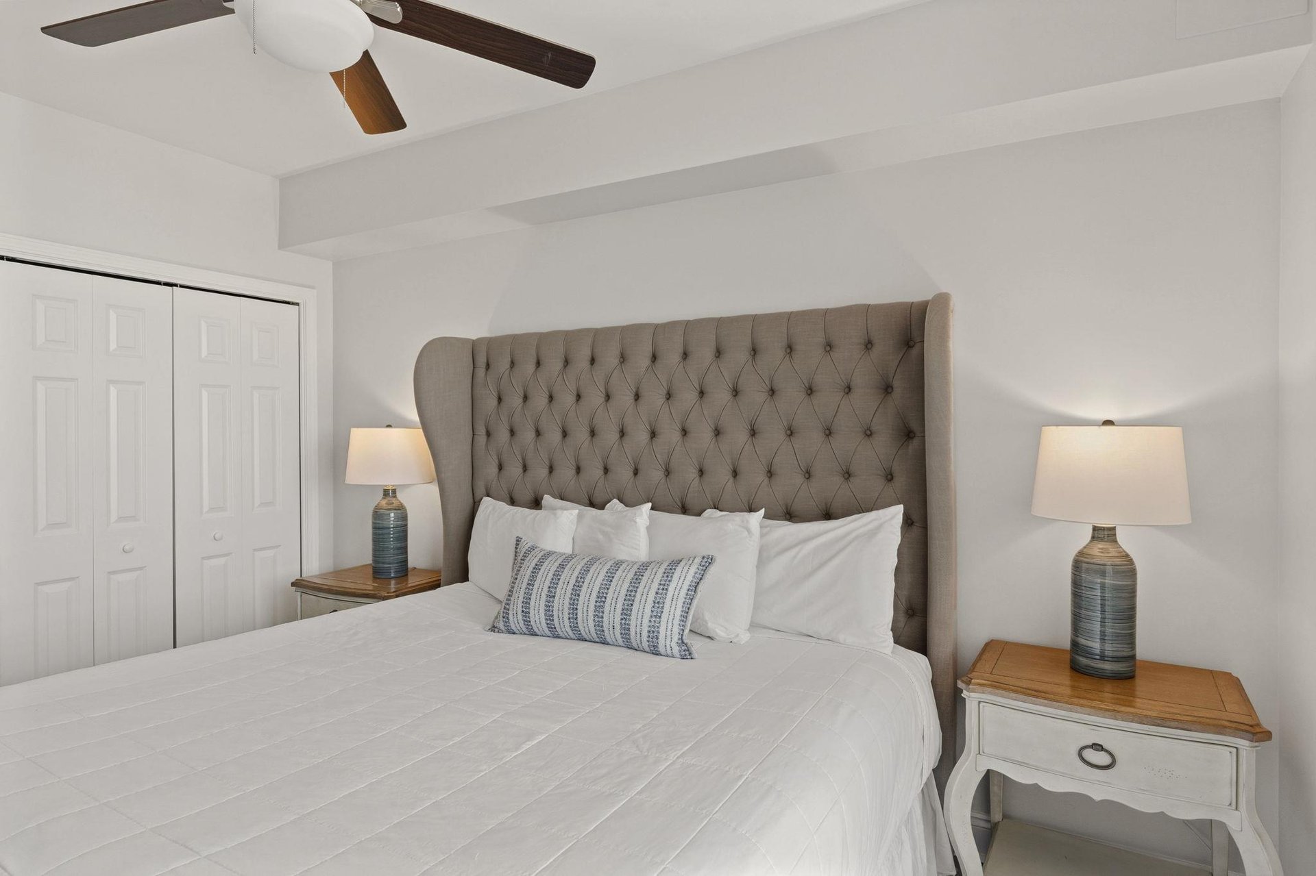 Sink into your luxurious tufted headboard bed with crisp linens and cozy accent pillow for peaceful nights.