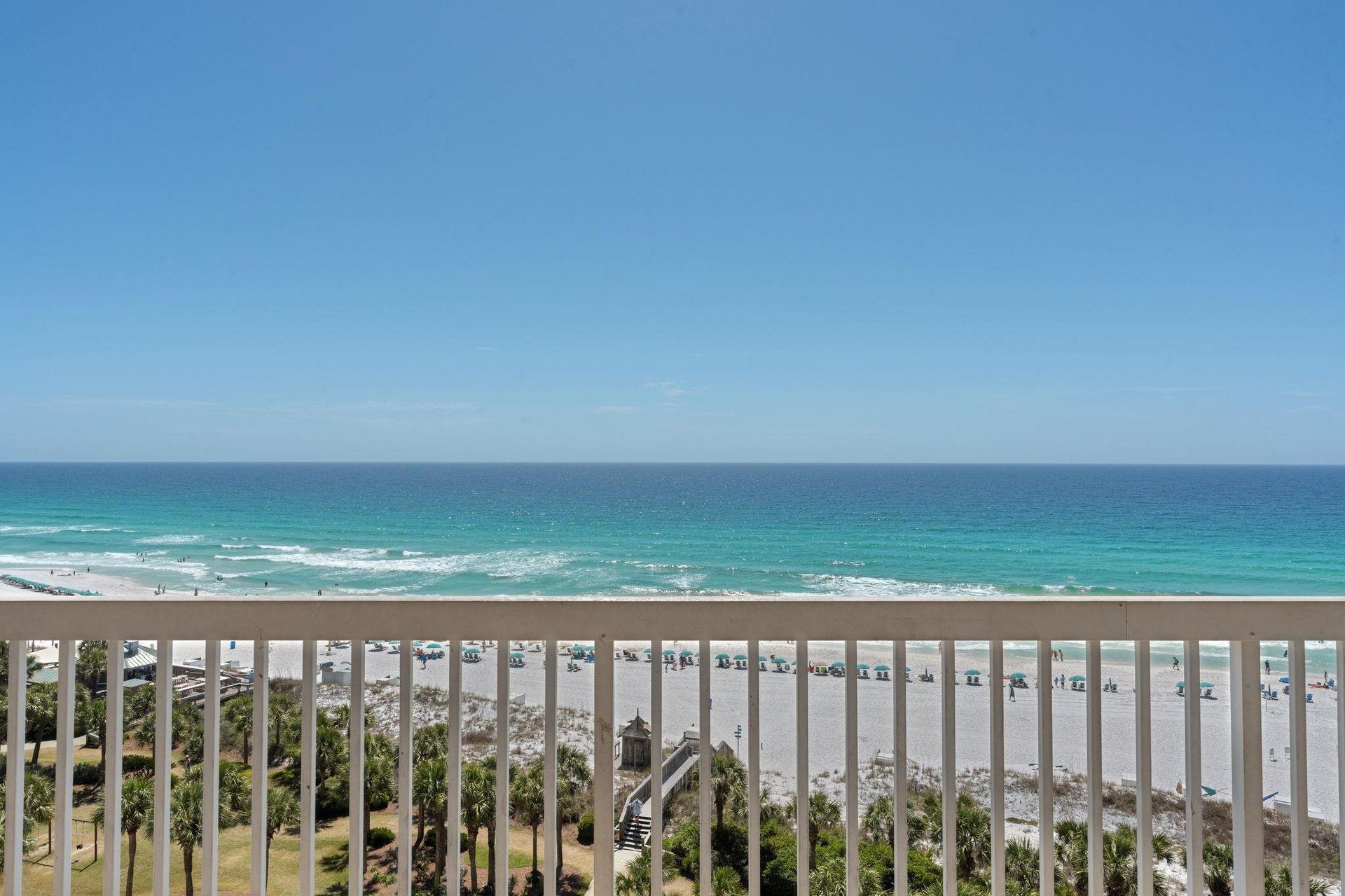 Breathtaking beachfront balcony view with pristine white sand and turquoise Gulf waters stretching endlessly before you.