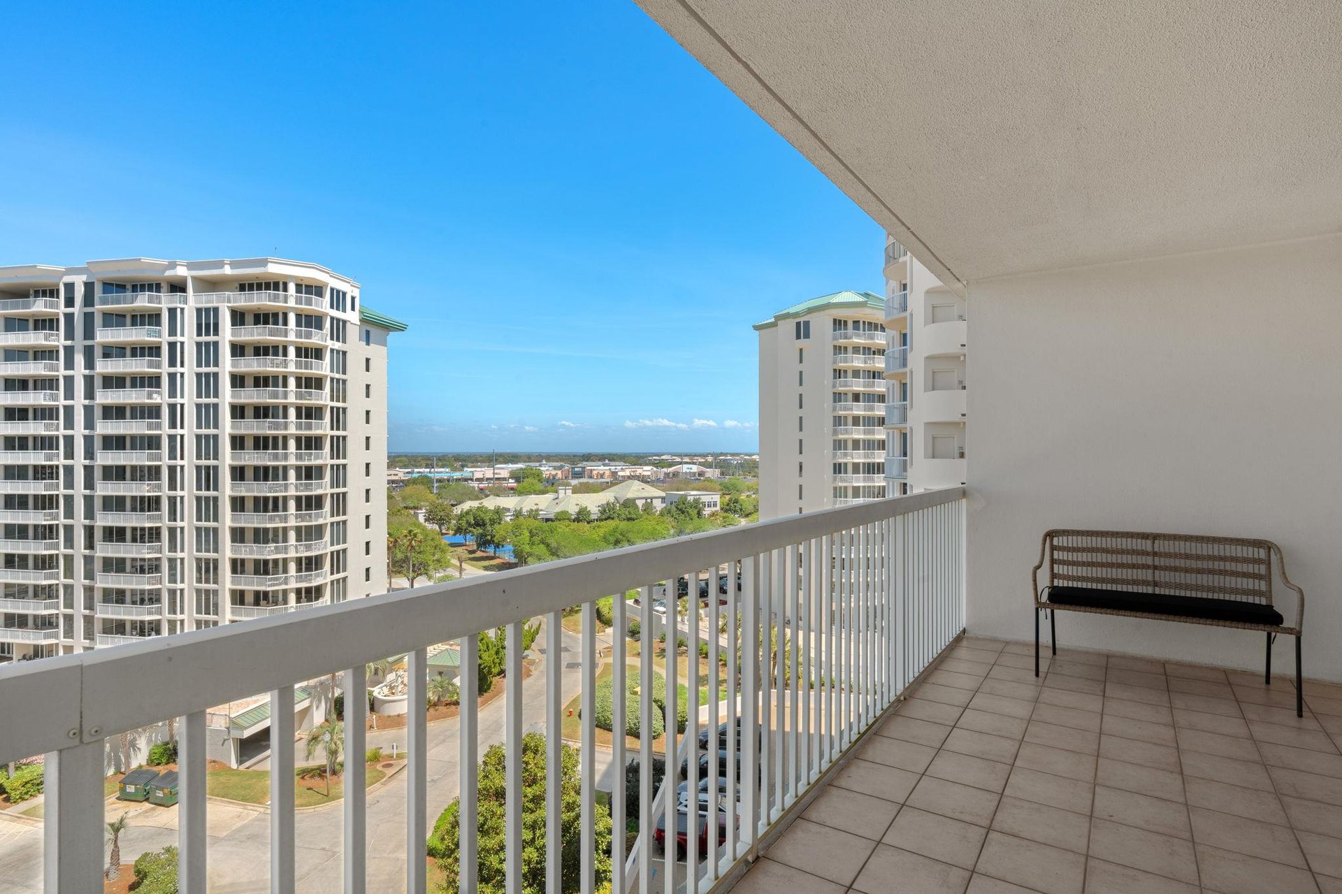 Landscaped grounds create a peaceful resort setting with clear blue skies above.