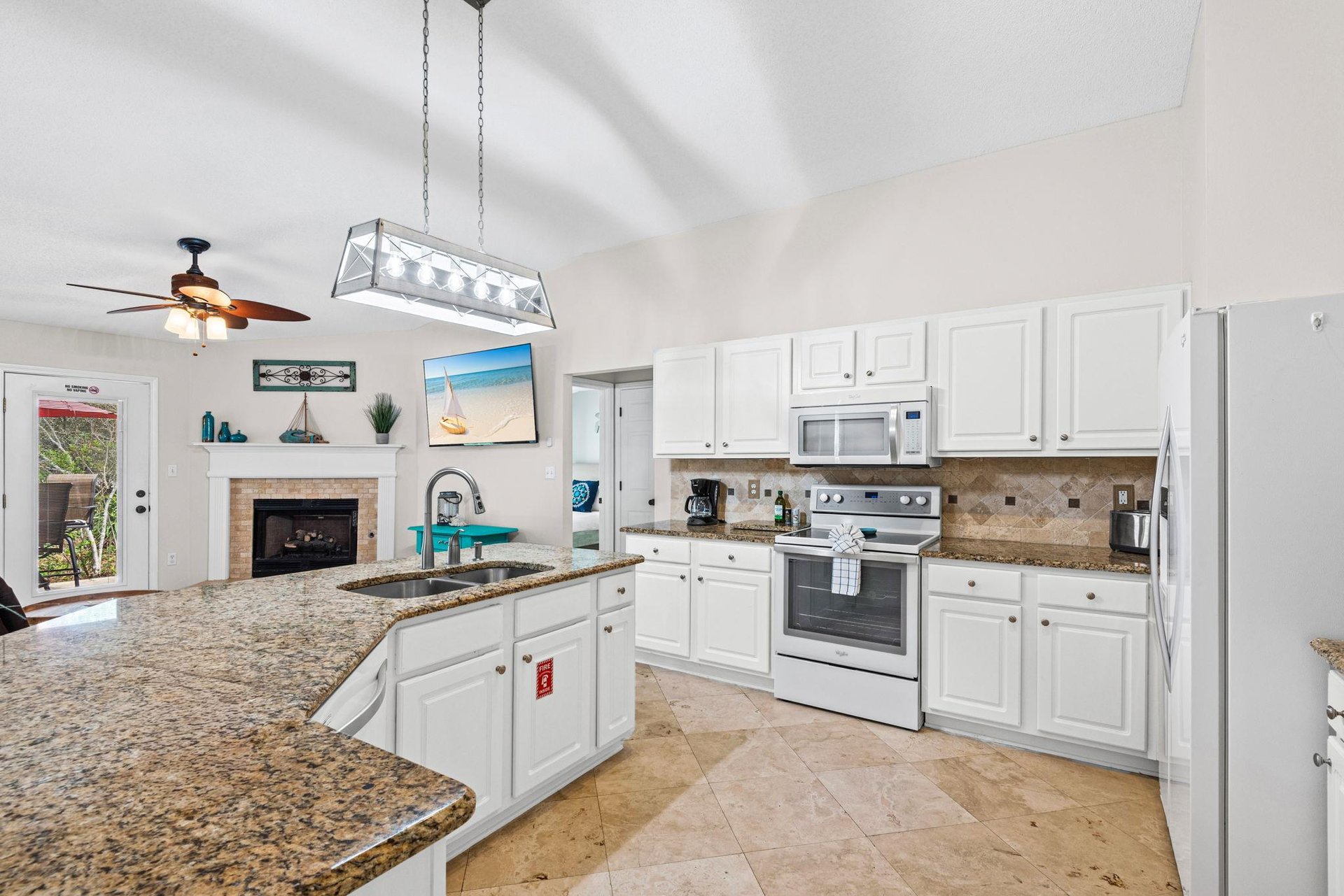 Your fully equipped kitchen features granite counters, stainless appliances, and flows into a cozy living area —perfect for cooking meals together.