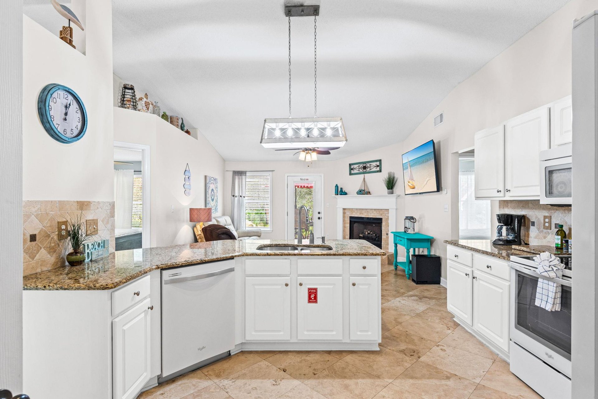Your fully equipped kitchen features granite countertops, modern appliances, and an open layout perfect for preparing meals while staying connected to your guests.