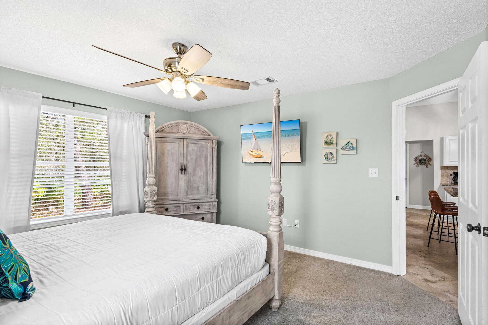 Drift off peacefully in your coastalthemed bedroom, complete with ceiling fan, spacious wardrobe, and charming nautical touches.