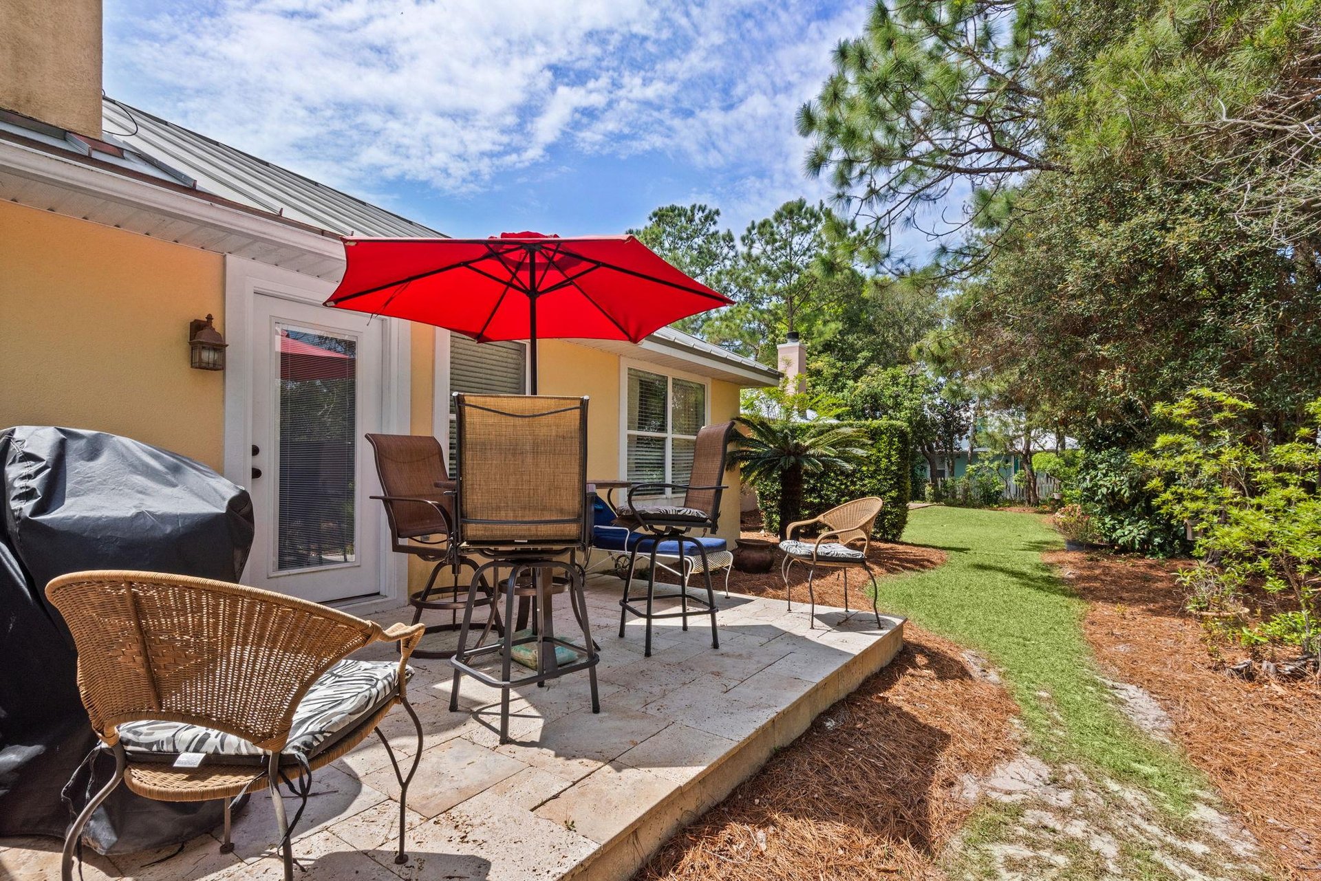 Enjoy outdoor dining on your private patio with comfortable seating surrounded by lush tropical landscaping