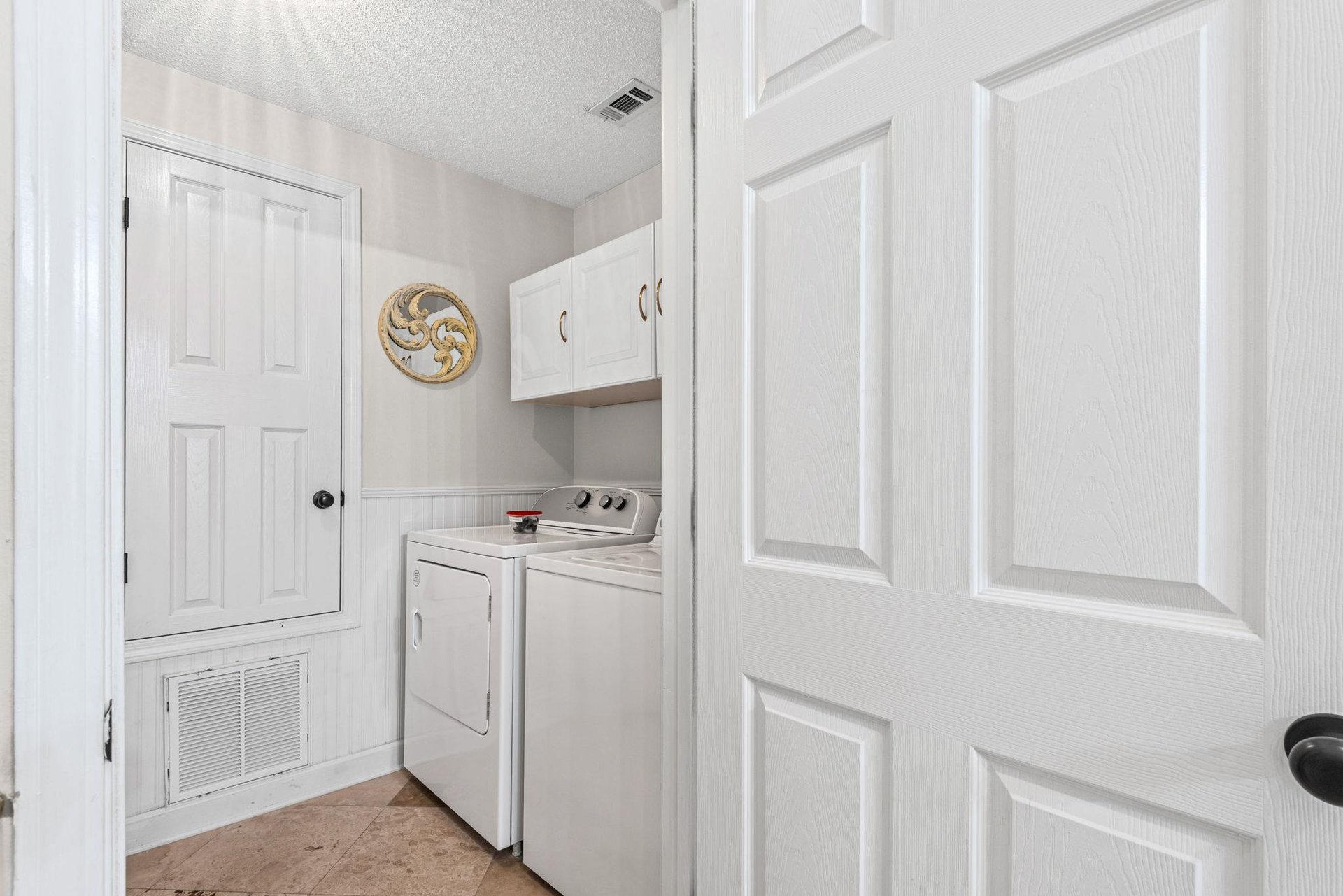Your dedicated laundry room features fullsize washer and dryer with convenient upper storage, making extended stays effortless.