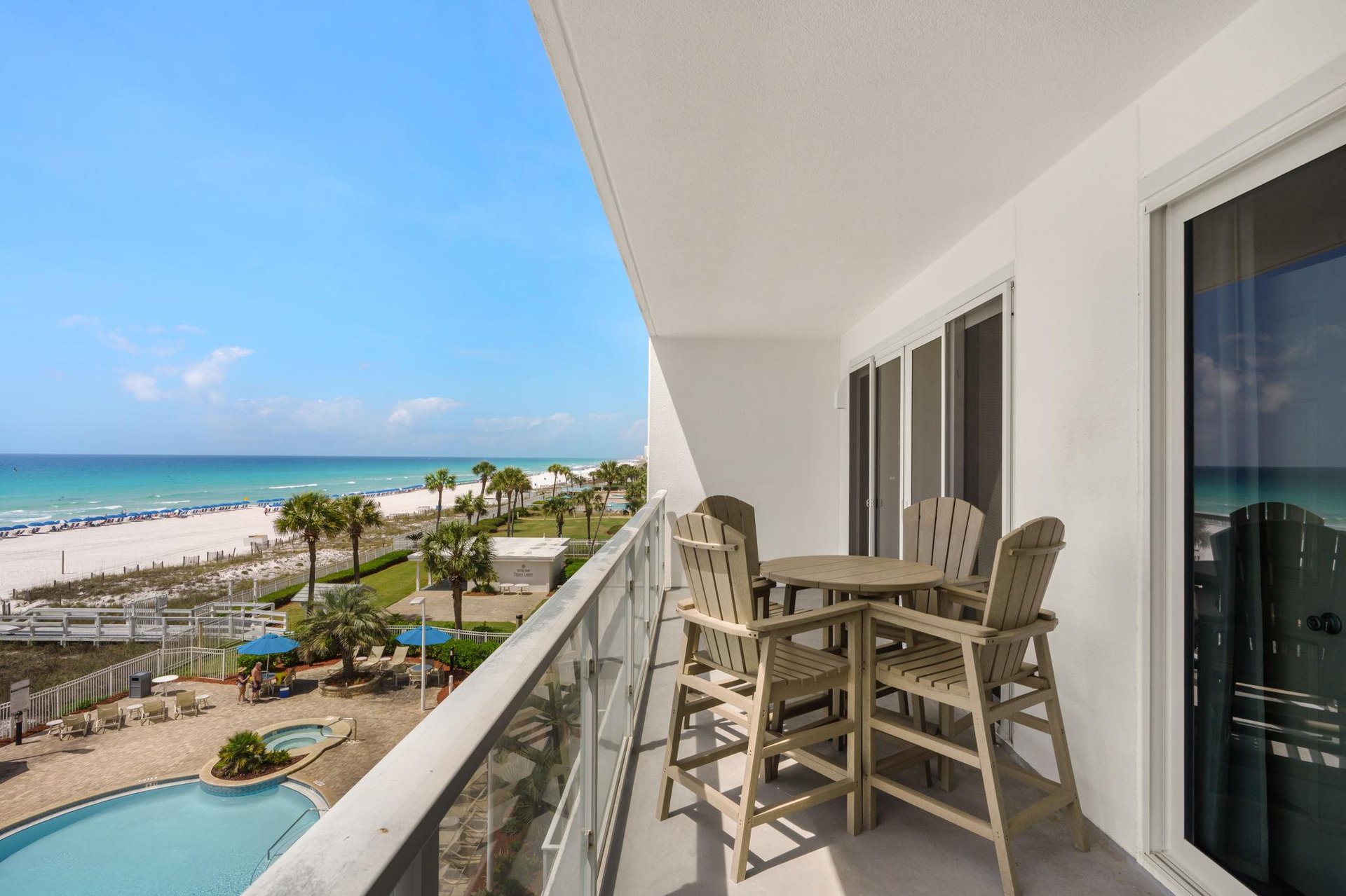 Spectacular beachfront balcony featuring pristine white sand, crystalclear waters, and tropical palms creating your perfect coastal retreat.