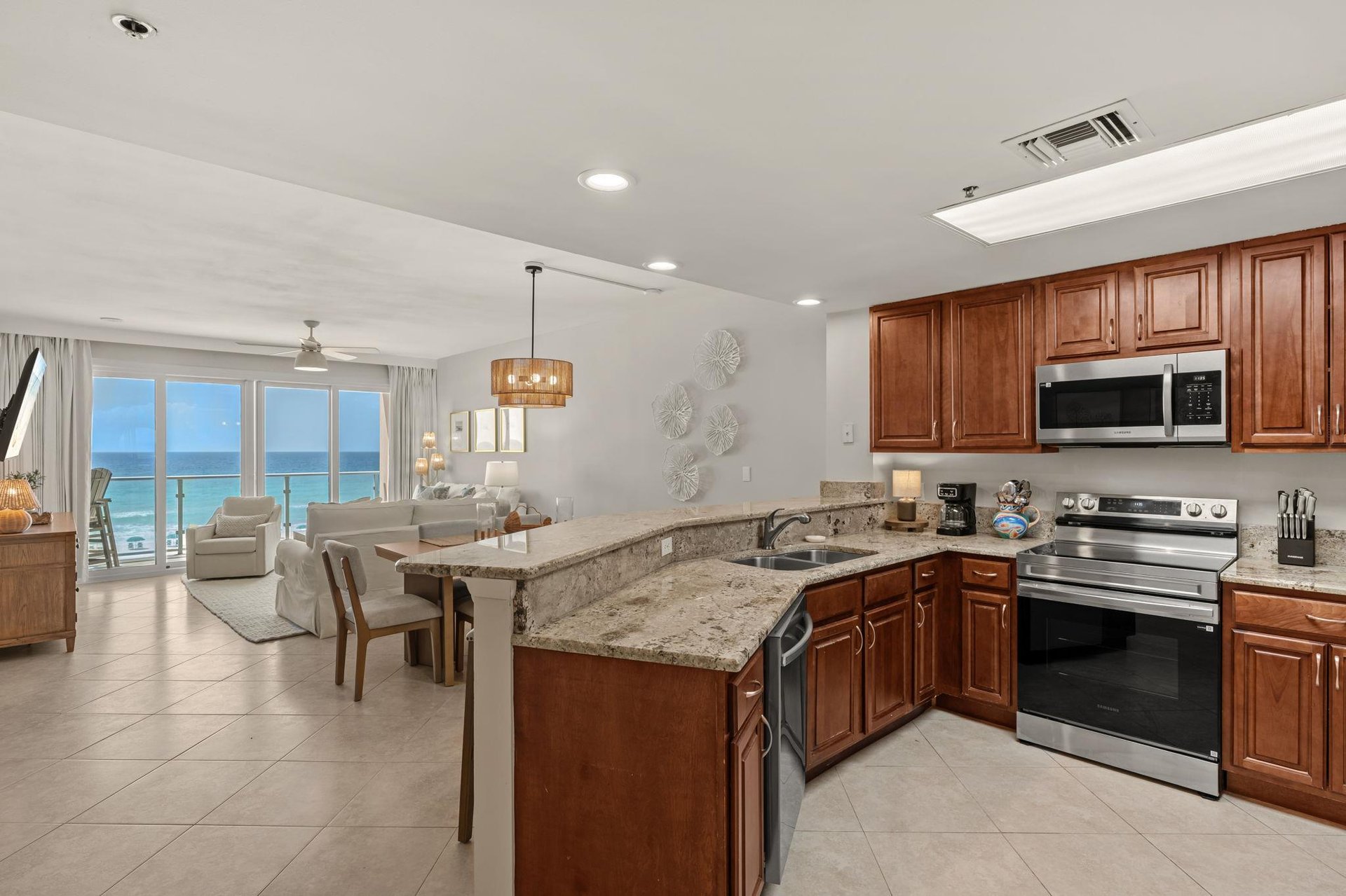 Your fully equipped kitchen flows seamlessly into the living space, with stunning ocean views creating the perfect backdrop for morning coffee.