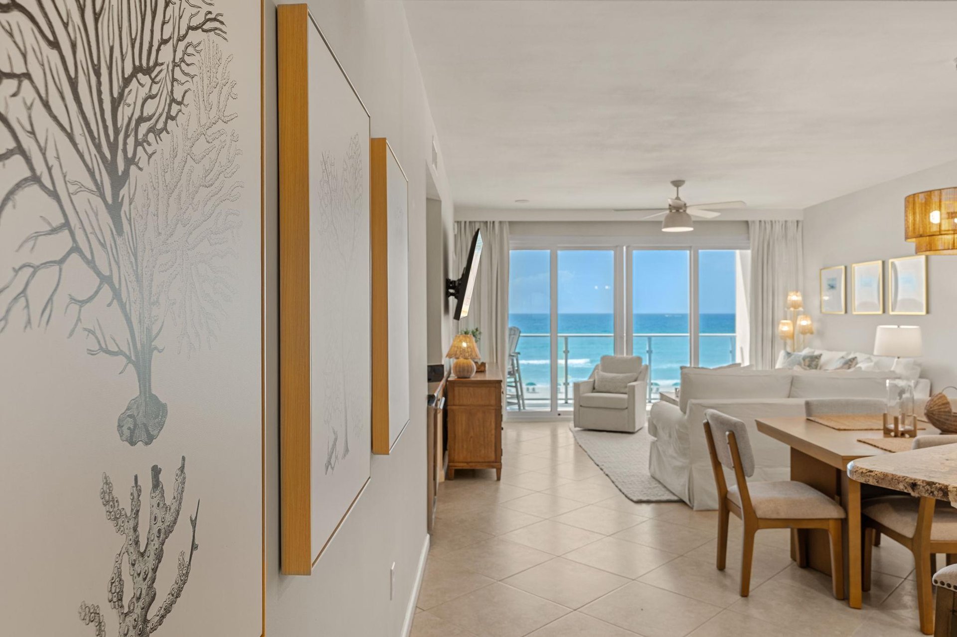Your bright oceanfront suite flows seamlessly from dining to living areas, with floortoceiling windows framing endless blue views.