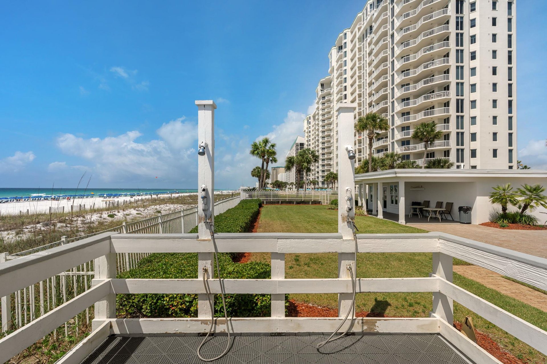 Beachfront property features outdoor shower facilities with direct beach access and stunning ocean views.