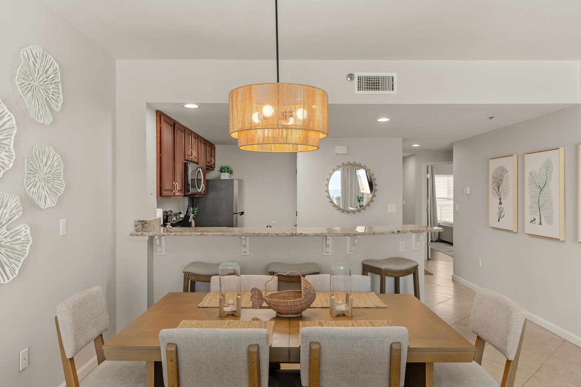 Your openconcept dining and kitchen space flows beautifully, where coastal elegance meets modern comfort for memorable meals together.