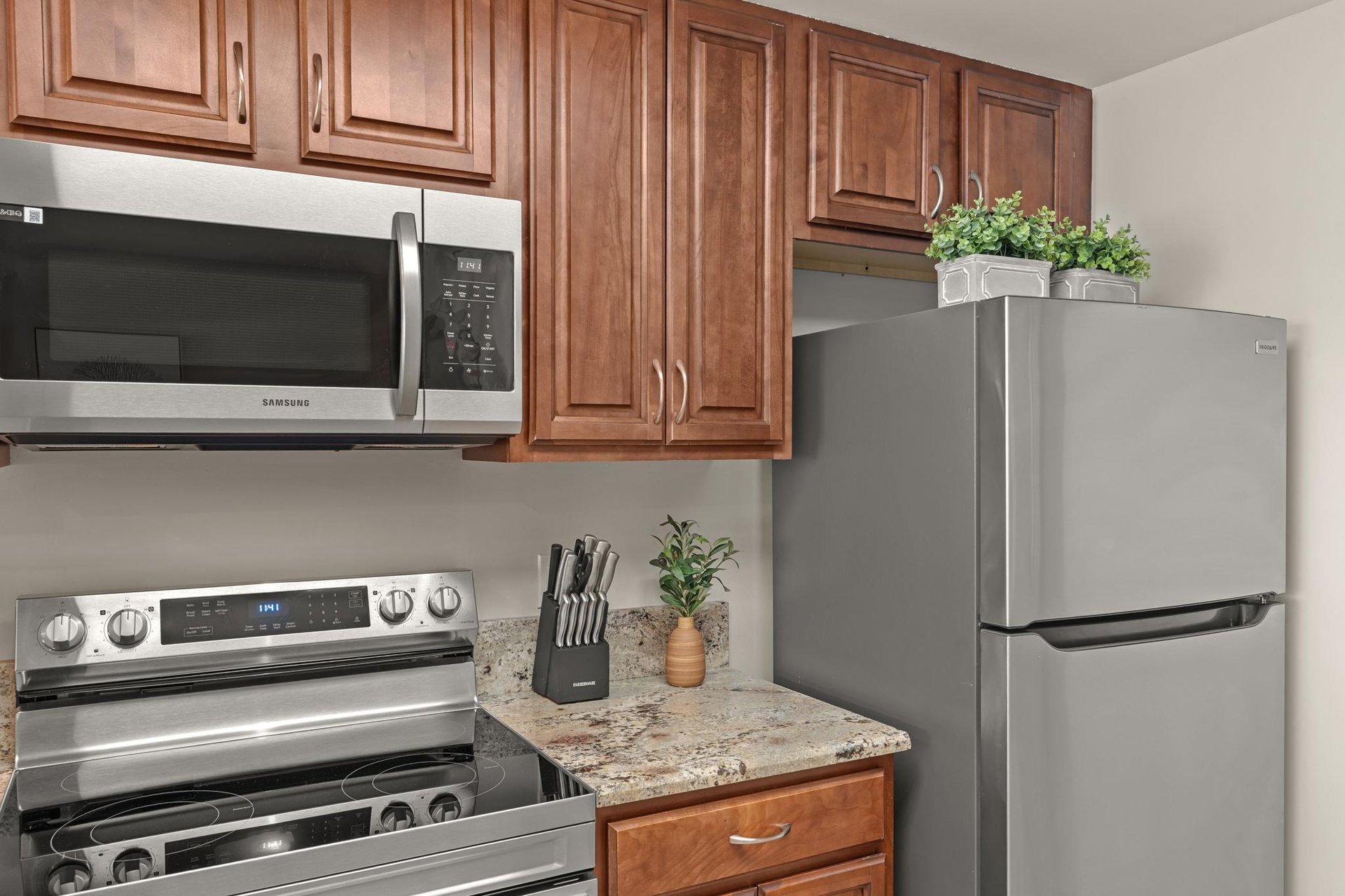 Your fully equipped kitchen features stainless steel appliances, warm wood cabinetry, and granite countertops.