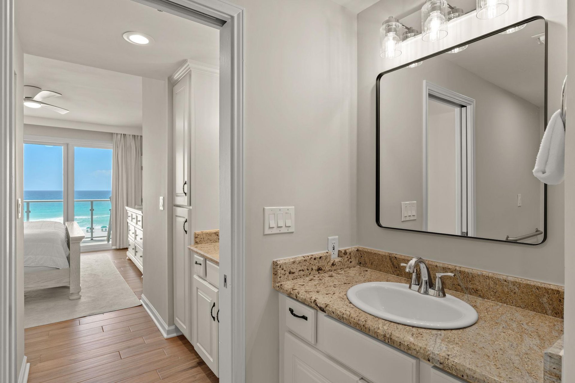 Step into your elegantly appointed bathroom where stunning ocean views greet you from the adjoining bedroom.