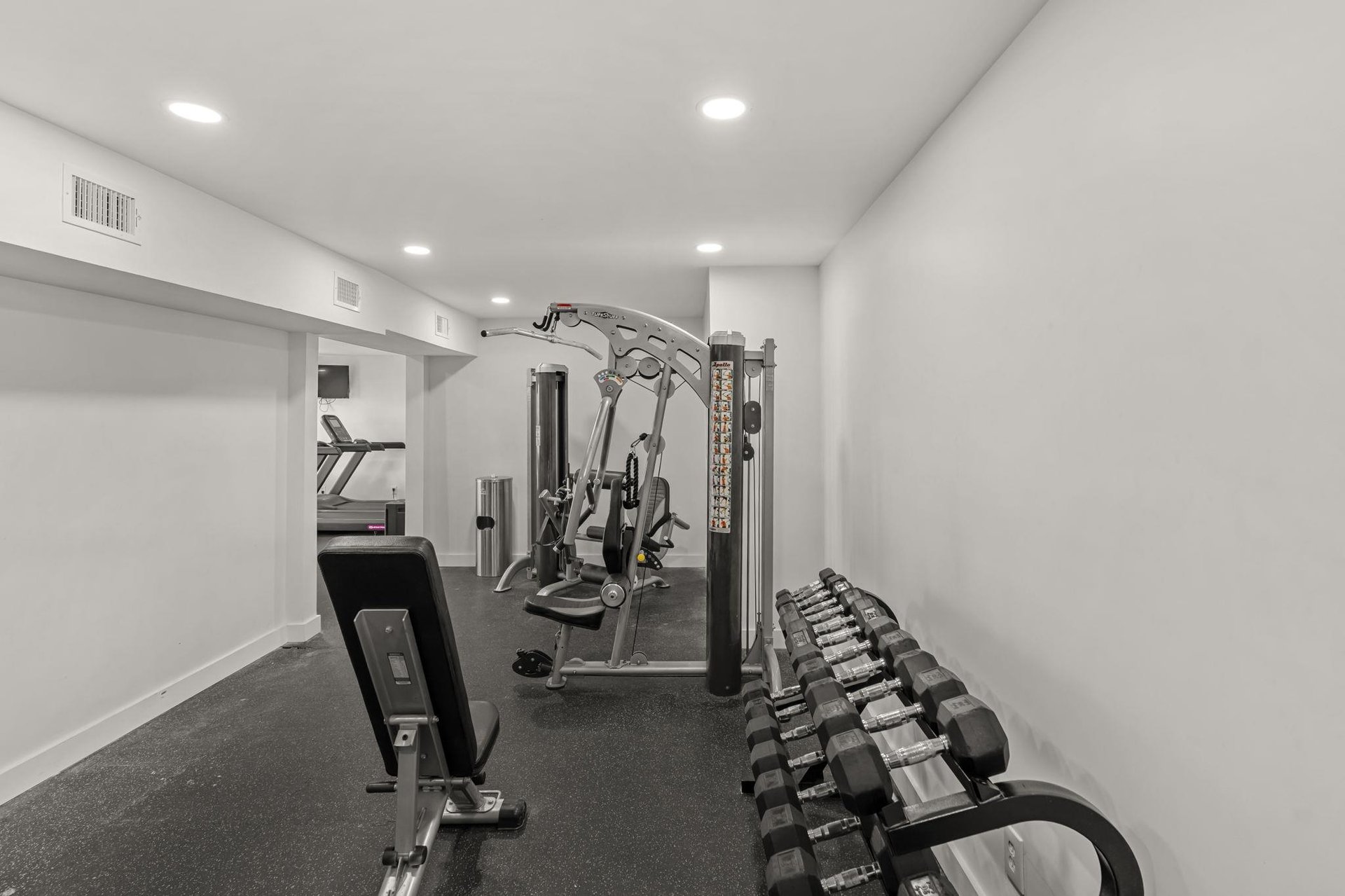 Your private fitness suite awaits with premium equipment, from free weights to multistation machines, all in a clean, welllit space.
