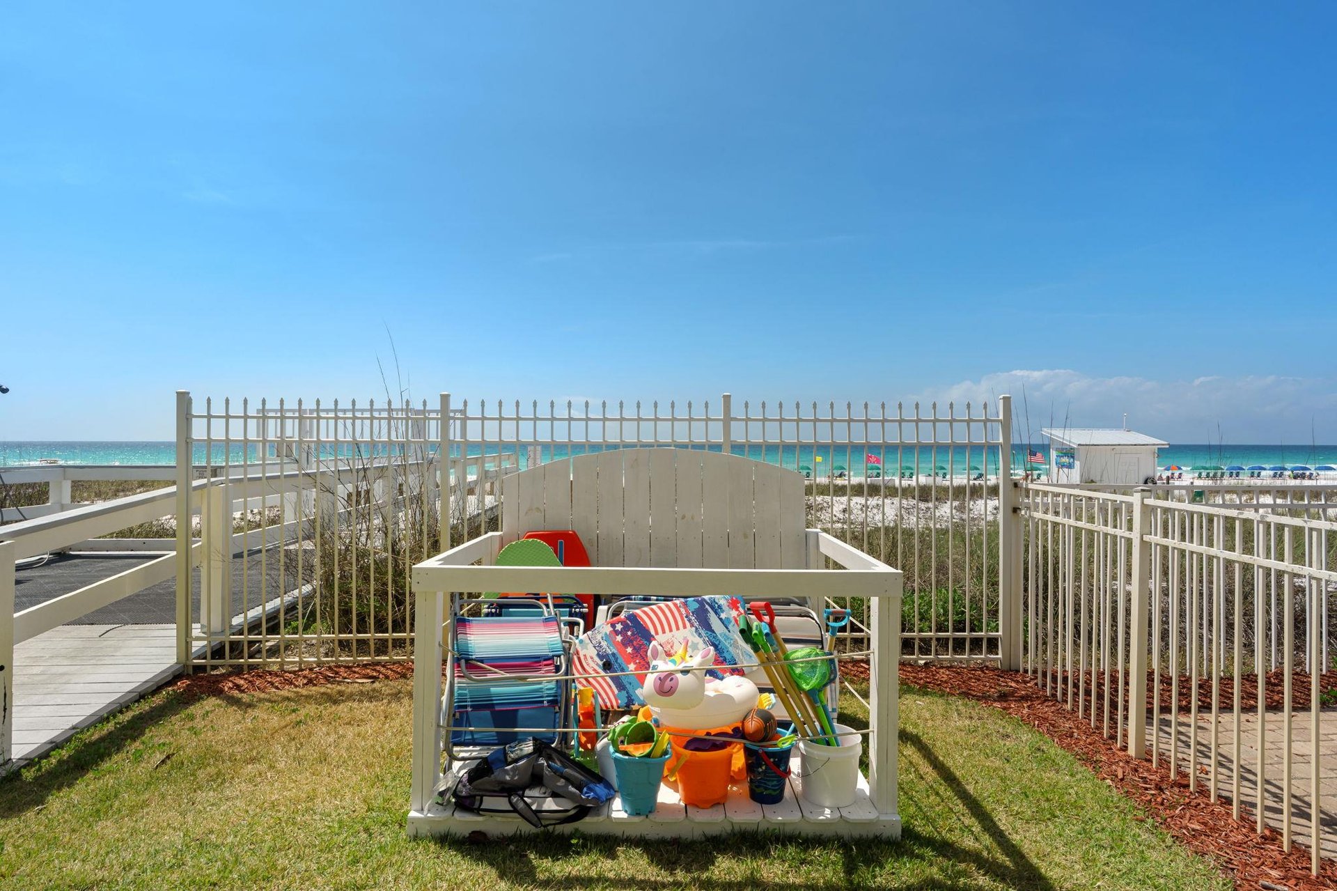 Beach gear storage bin stocked with chairs, umbrellas, and toys first come first serve for sharing.