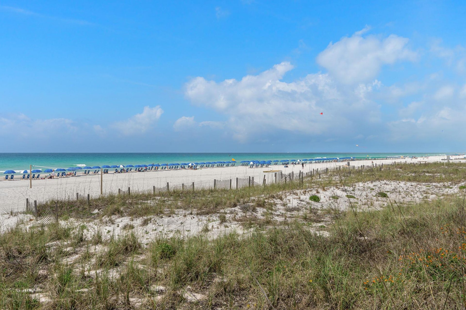 Beautiful pristine beach with turquoise waters and white sand, perfect for relaxation and seaside activities.