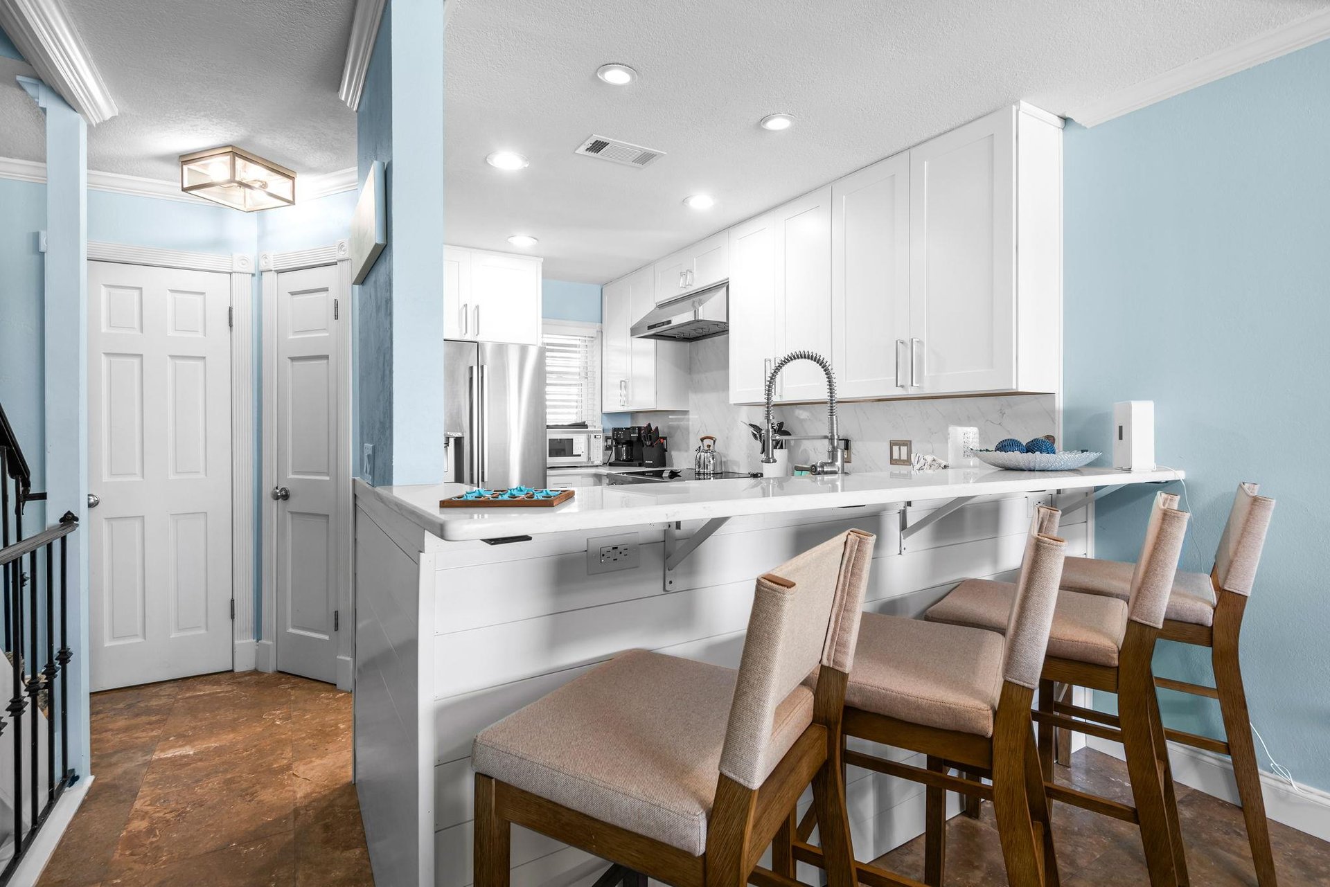 The modern kitchen features a breakfast bar perfect for morning coffee or casual meals.