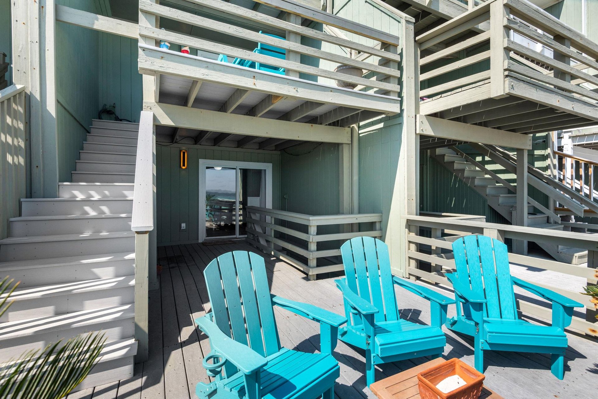 Relax in bright turquoise Adirondack chairs on one of the private decks
