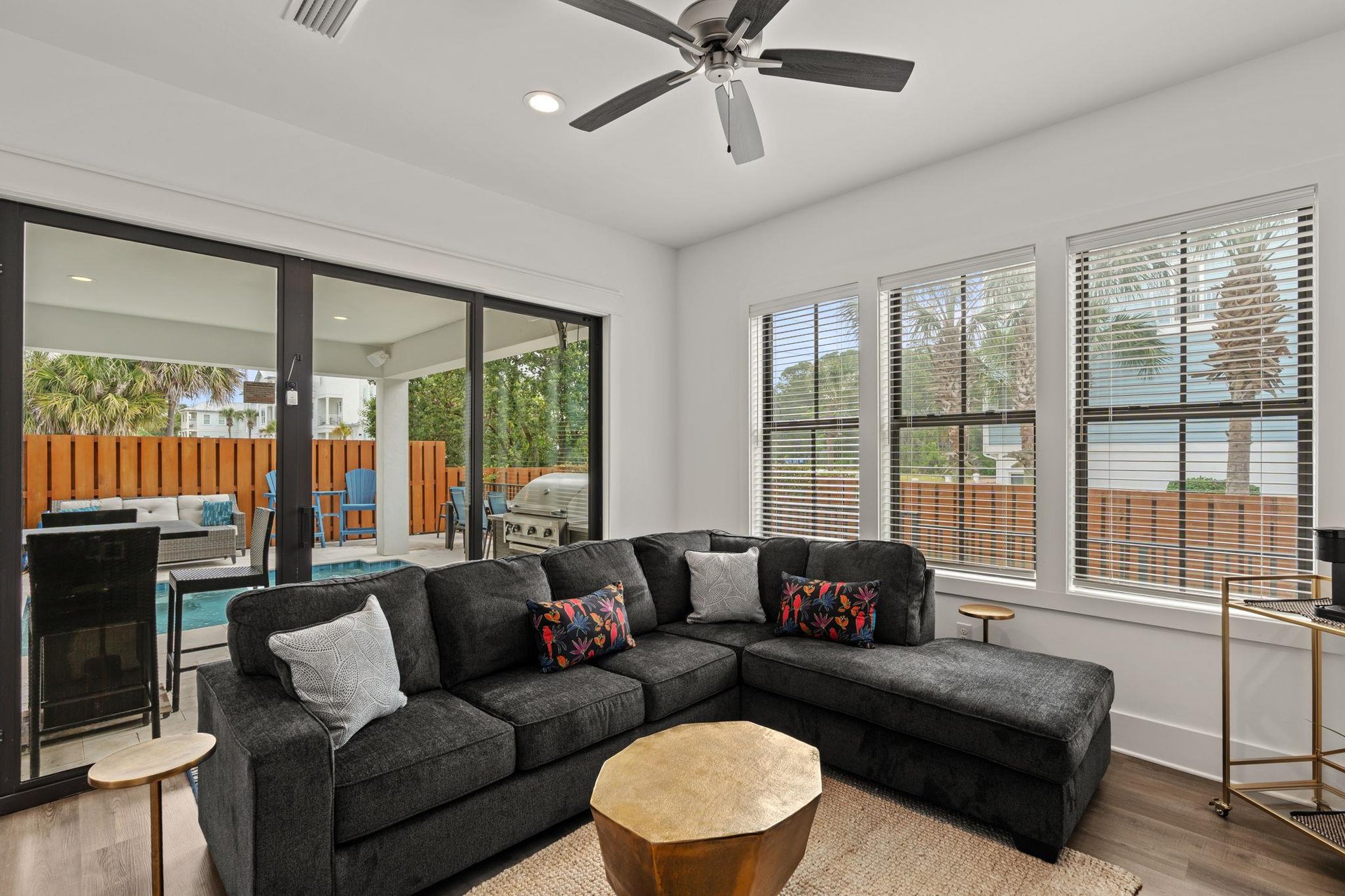 Settle into this inviting living space where natural light streams through expansive windows. Beyond the sliding doors, your private patio and pool await for seamless indooroutdoor living.