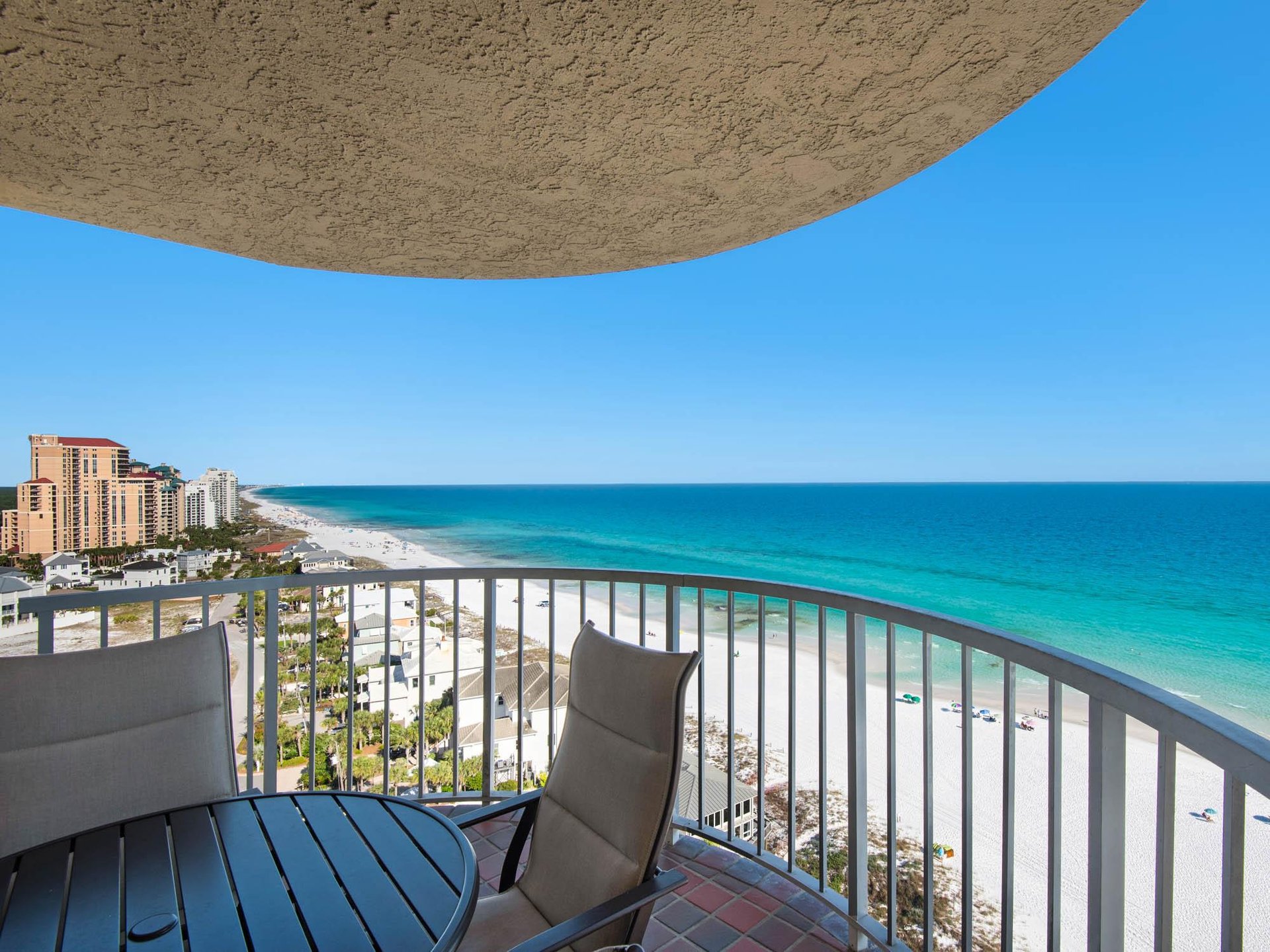 Unwind on your private balcony with stunning coastal views, where turquoise waters meet white sand and gentle gulf breezes create the perfect escape.