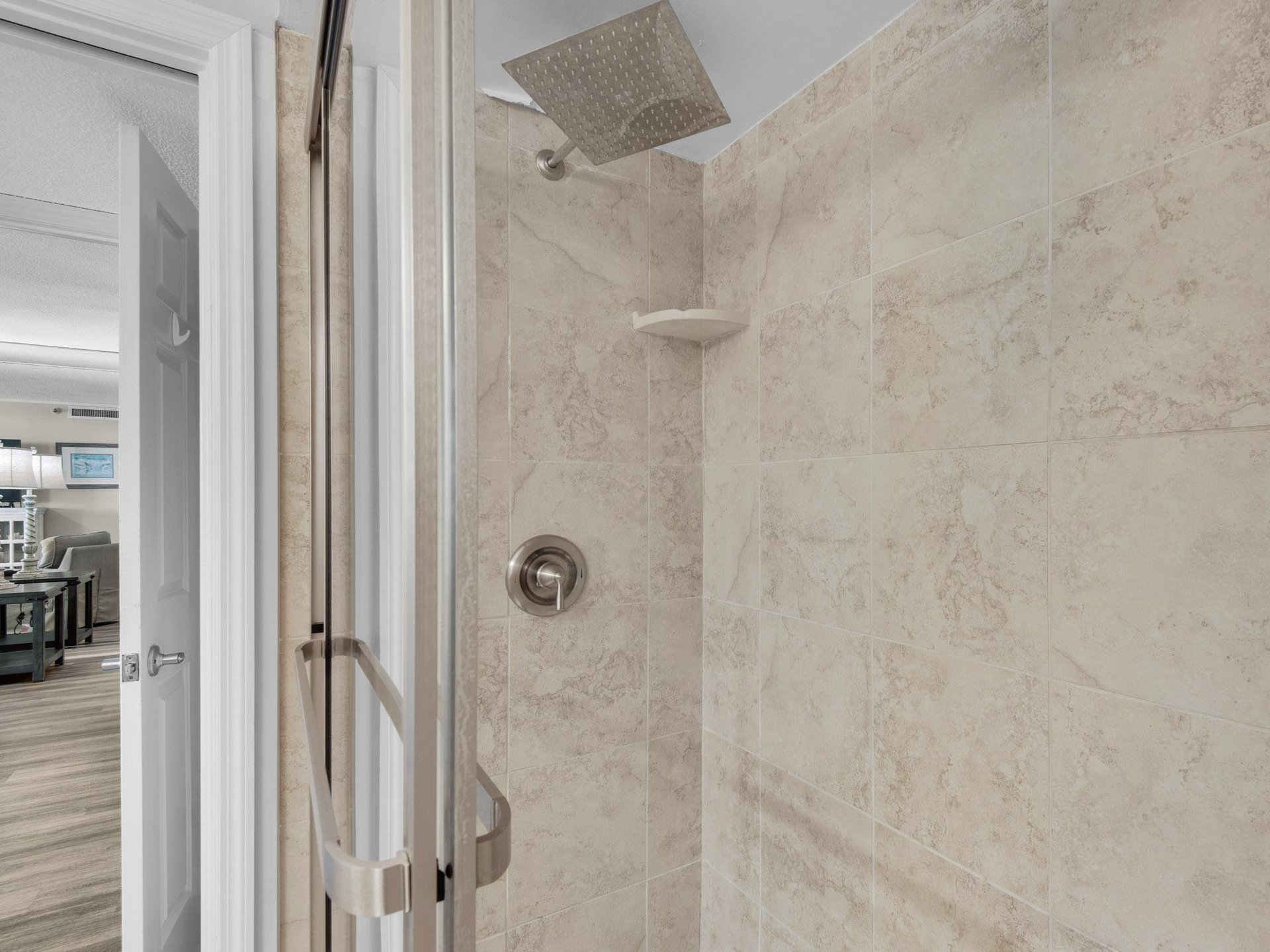 Step into your private rainfall shower with elegant tile work and modern fixtures, perfect for refreshing after a day of adventure.