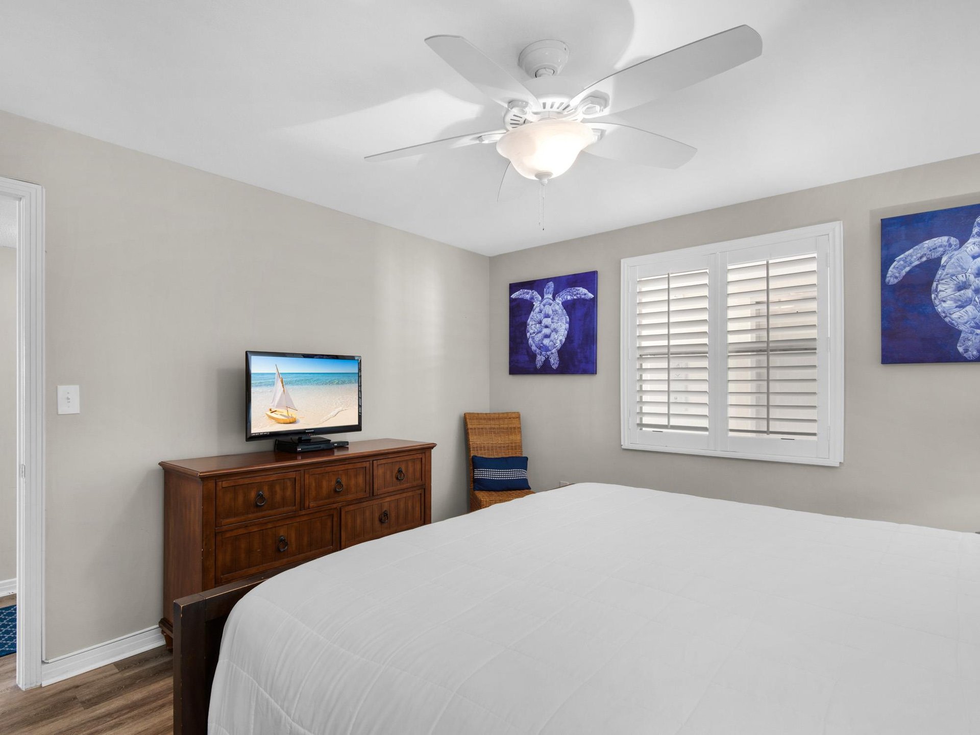 Bedroom 2complete with a ceiling fan, flat screen TV, and charming sea turtle artwork to make you feel right at home.