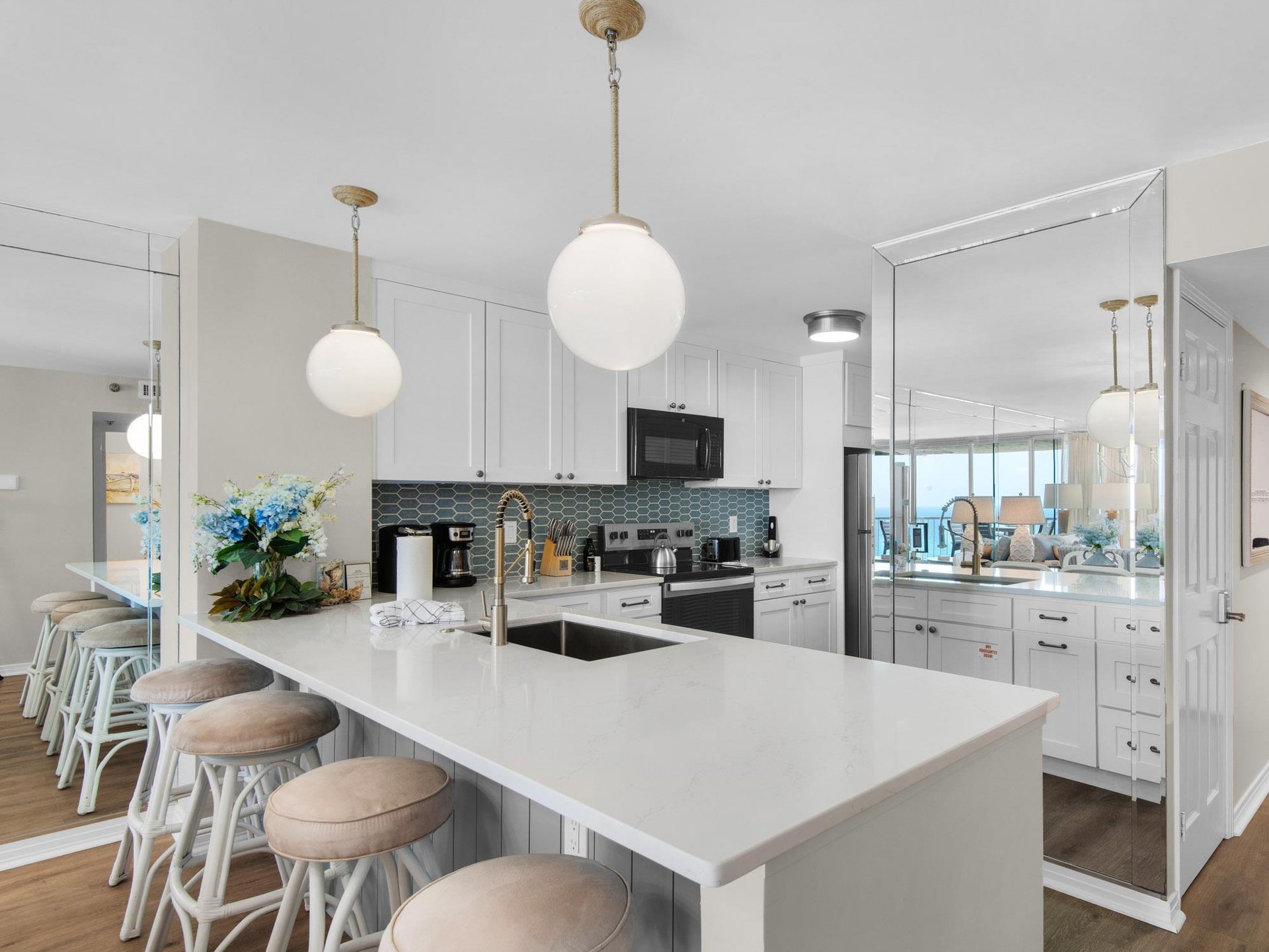 Picture yourself cooking in this bright, beachside kitchen with gulf views, spacious counters, and bar seating perfect for morning coffee with family and friends.